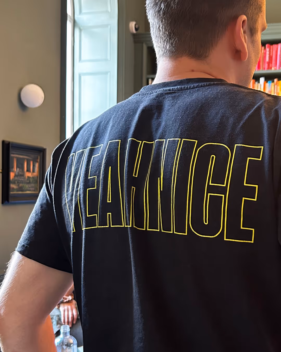 A woman with her eyes closed with a rainbow light on her face.