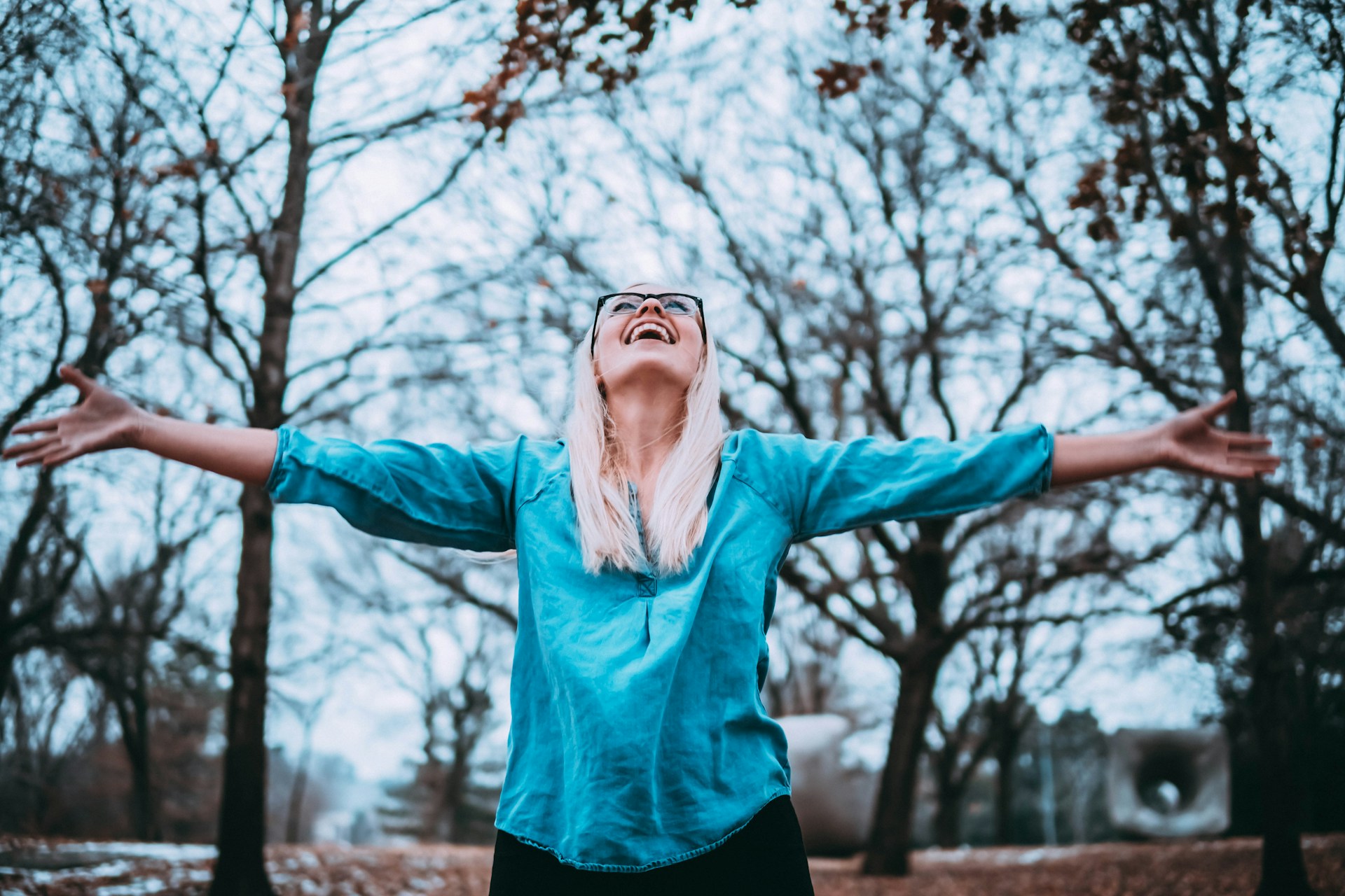A healthy middle-aged woman spreading her arms out in joy