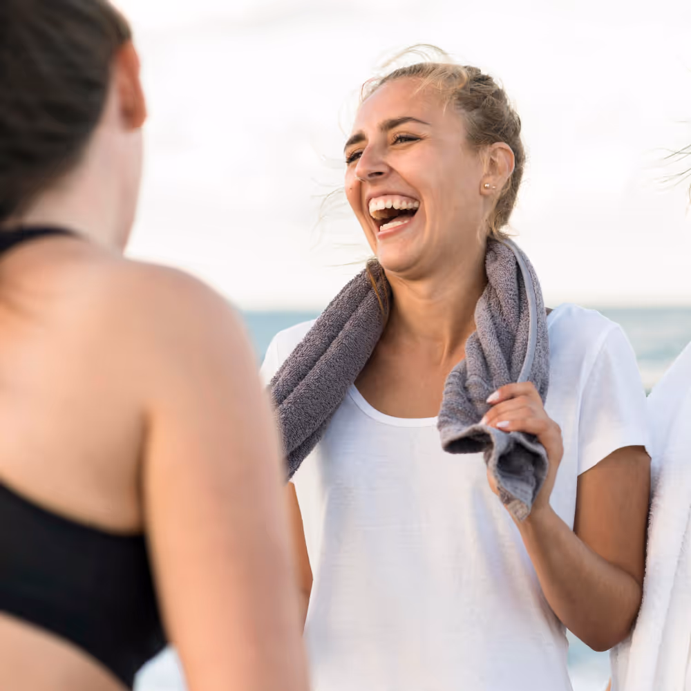 Two woman looking at each other and laughing