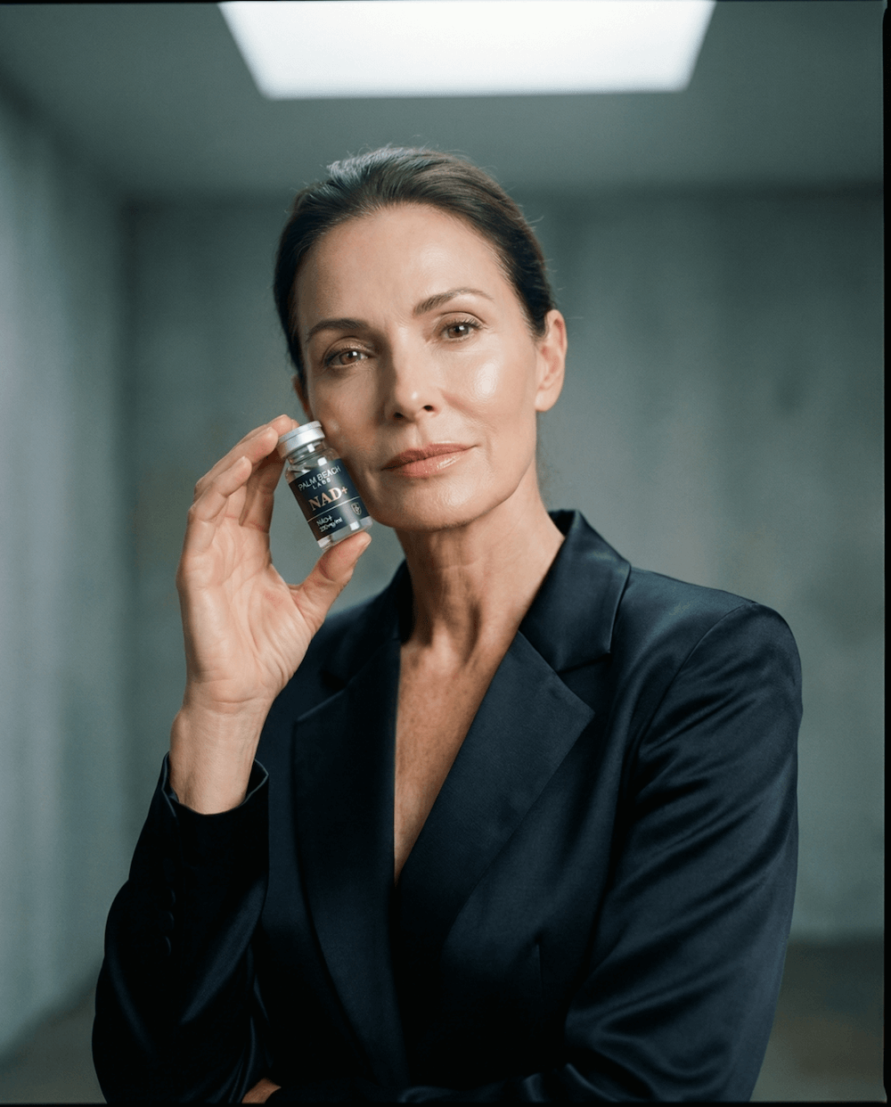 Woman holding NAD+ vial