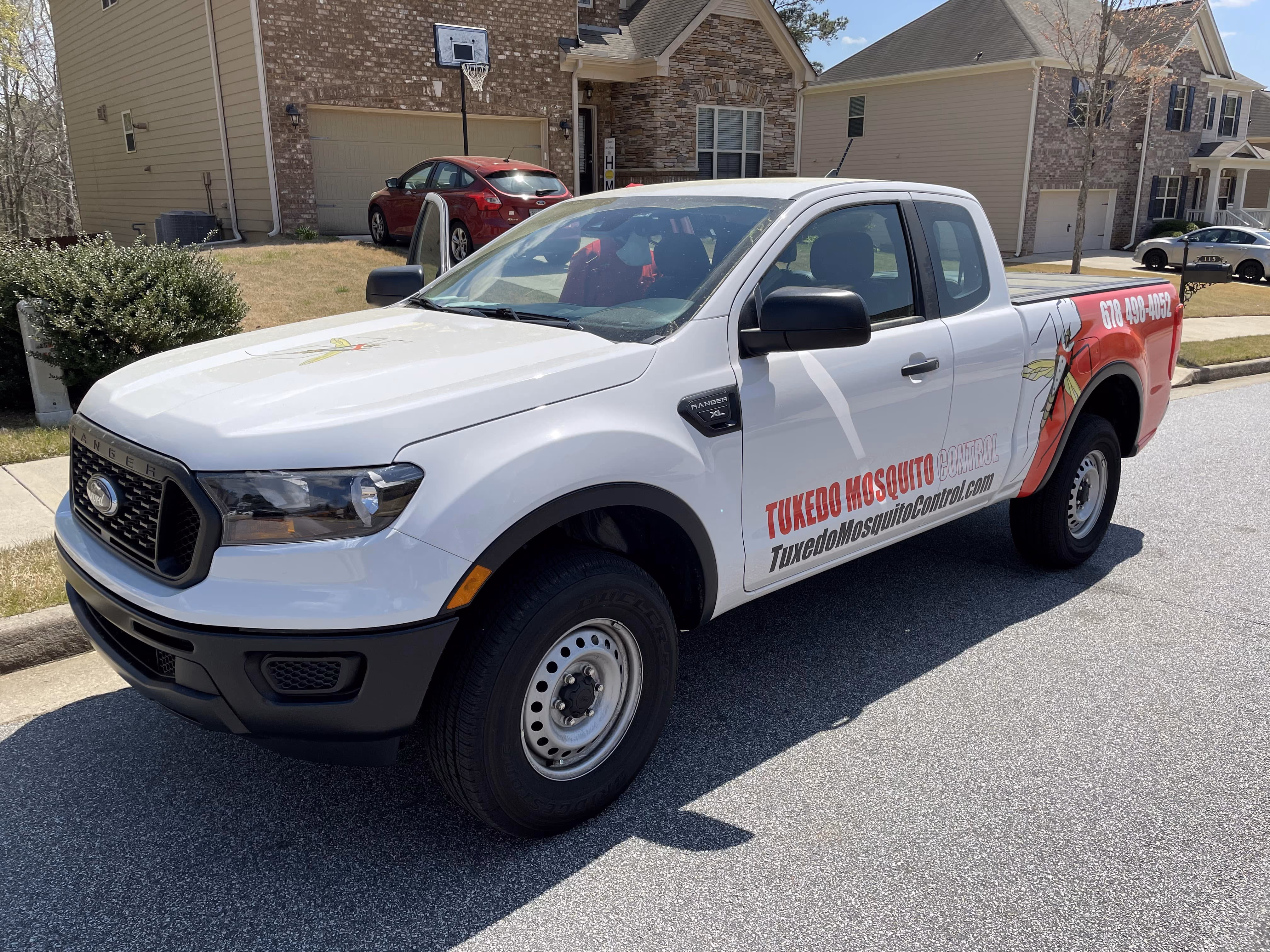 Tuxedo Mosquito Control service truck at a home
