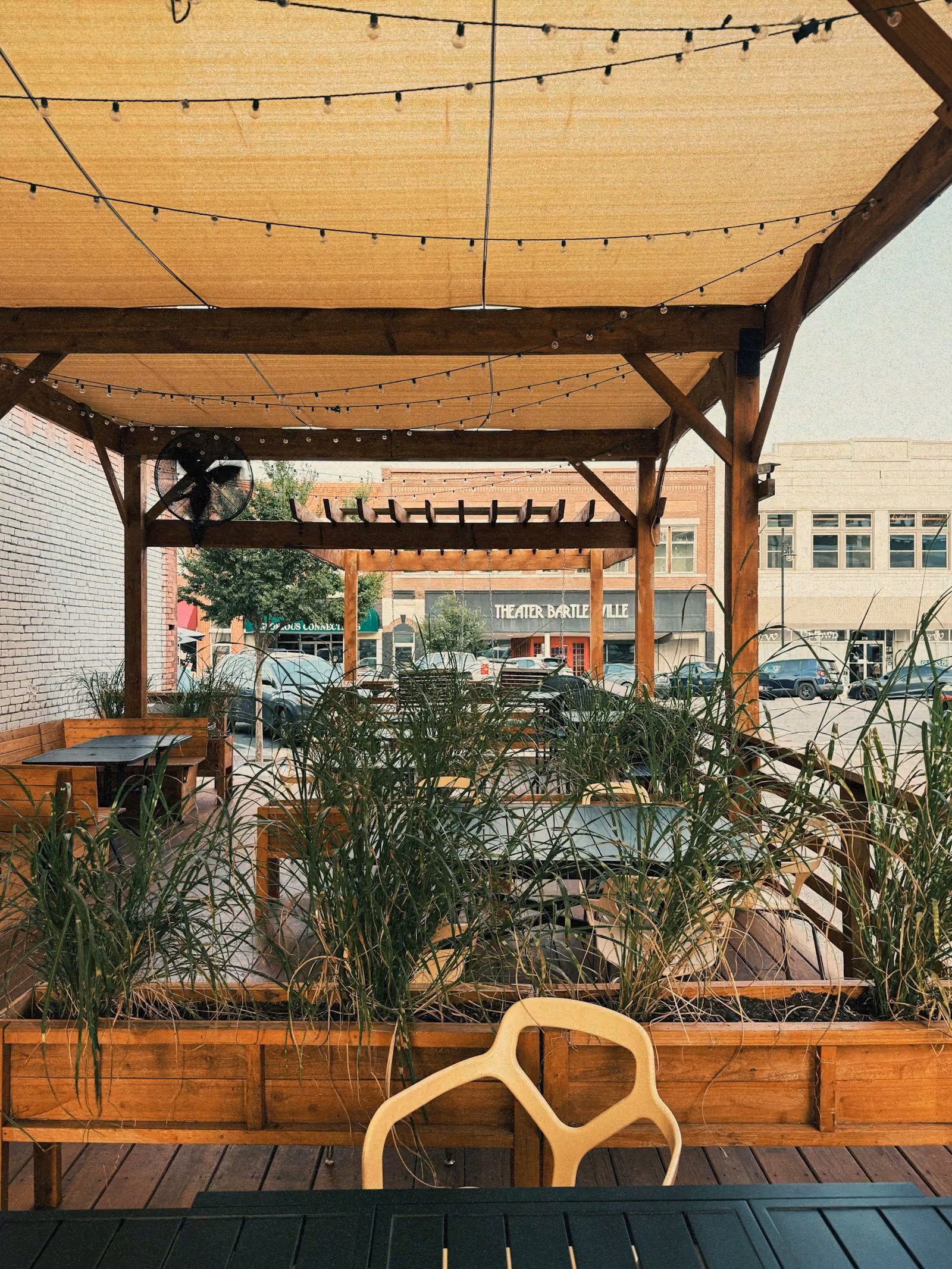 Patio seating with string lights and plants