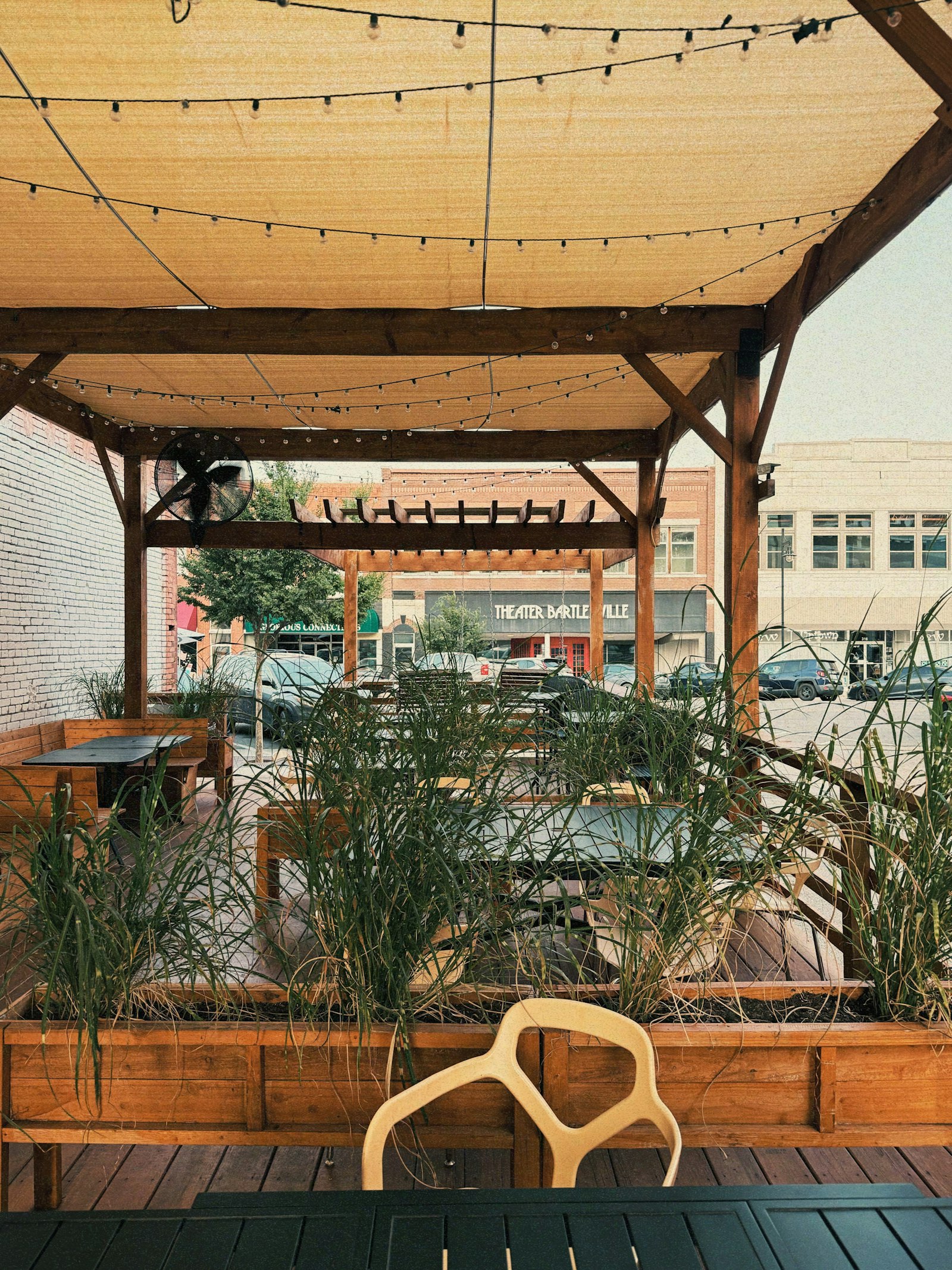Patio seating with string lights and plants