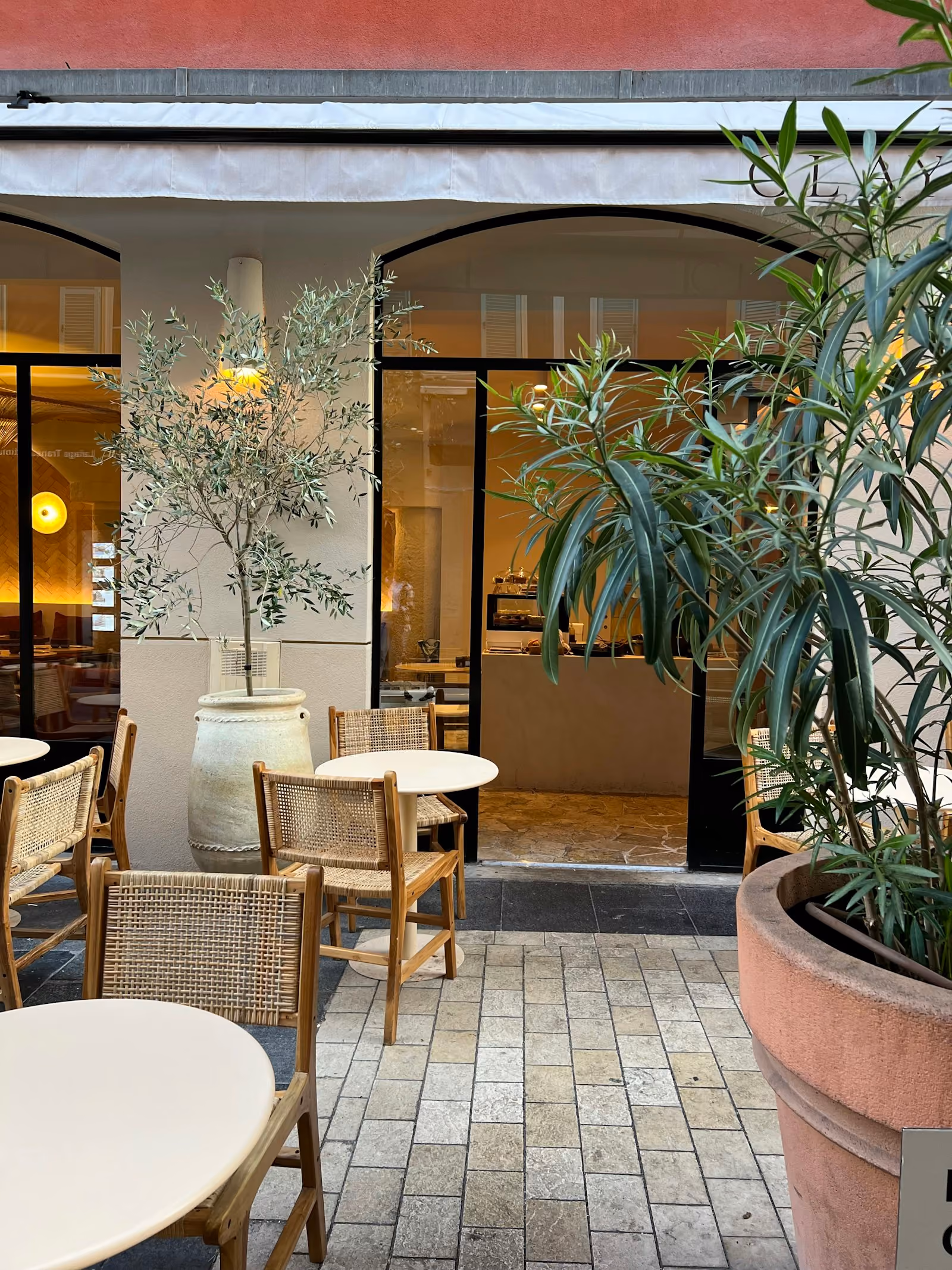 Patio with tables, chairs and a potted plant