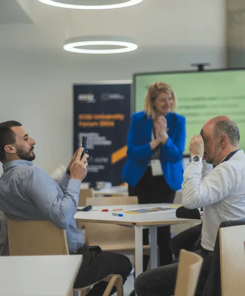 ECIU staff members presenting at interactive workshop session with digital displays