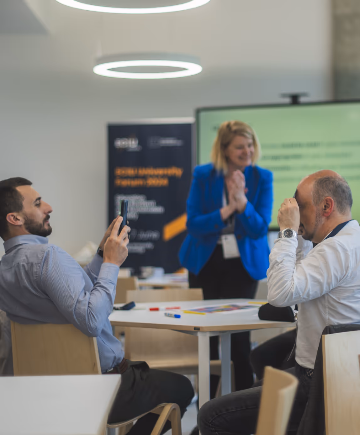 ECIU staff members presenting at interactive workshop session with digital displays