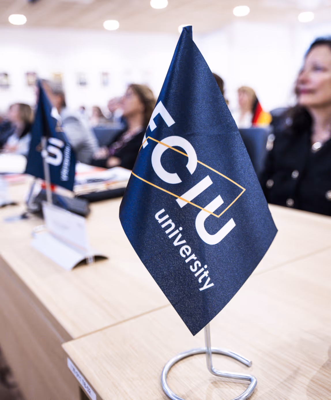 ECIU University flag displayed on conference table at networking event