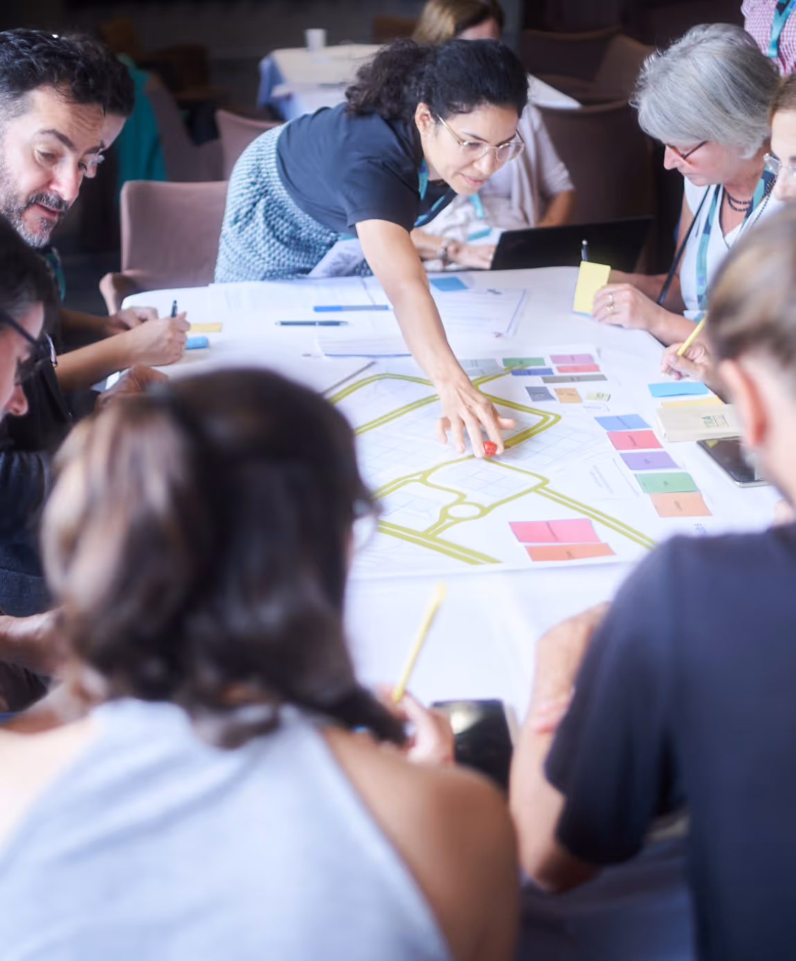 CIU participants engaged in design thinking workshop with visual mapping and colorful sticky notes on collaborative workspace