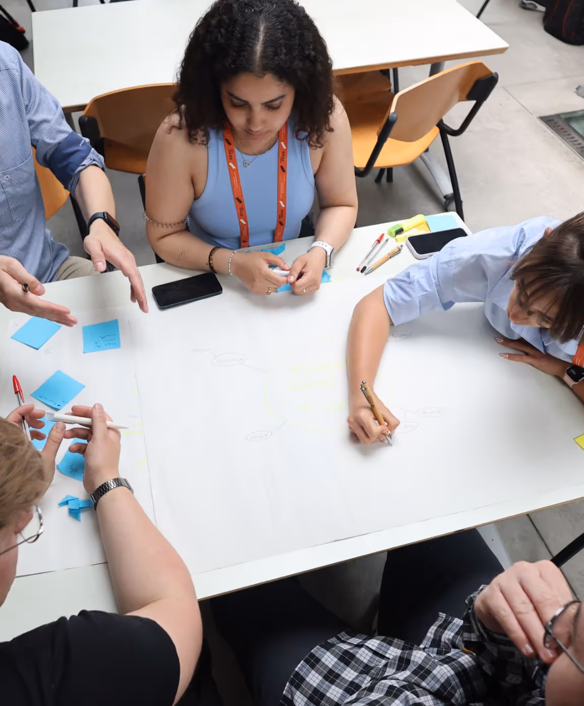 ECIU workshop participants brainstorming with sticky notes during collaborative ideation exercise