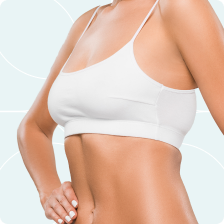 A woman wearing a white sports bra with a light blue background.