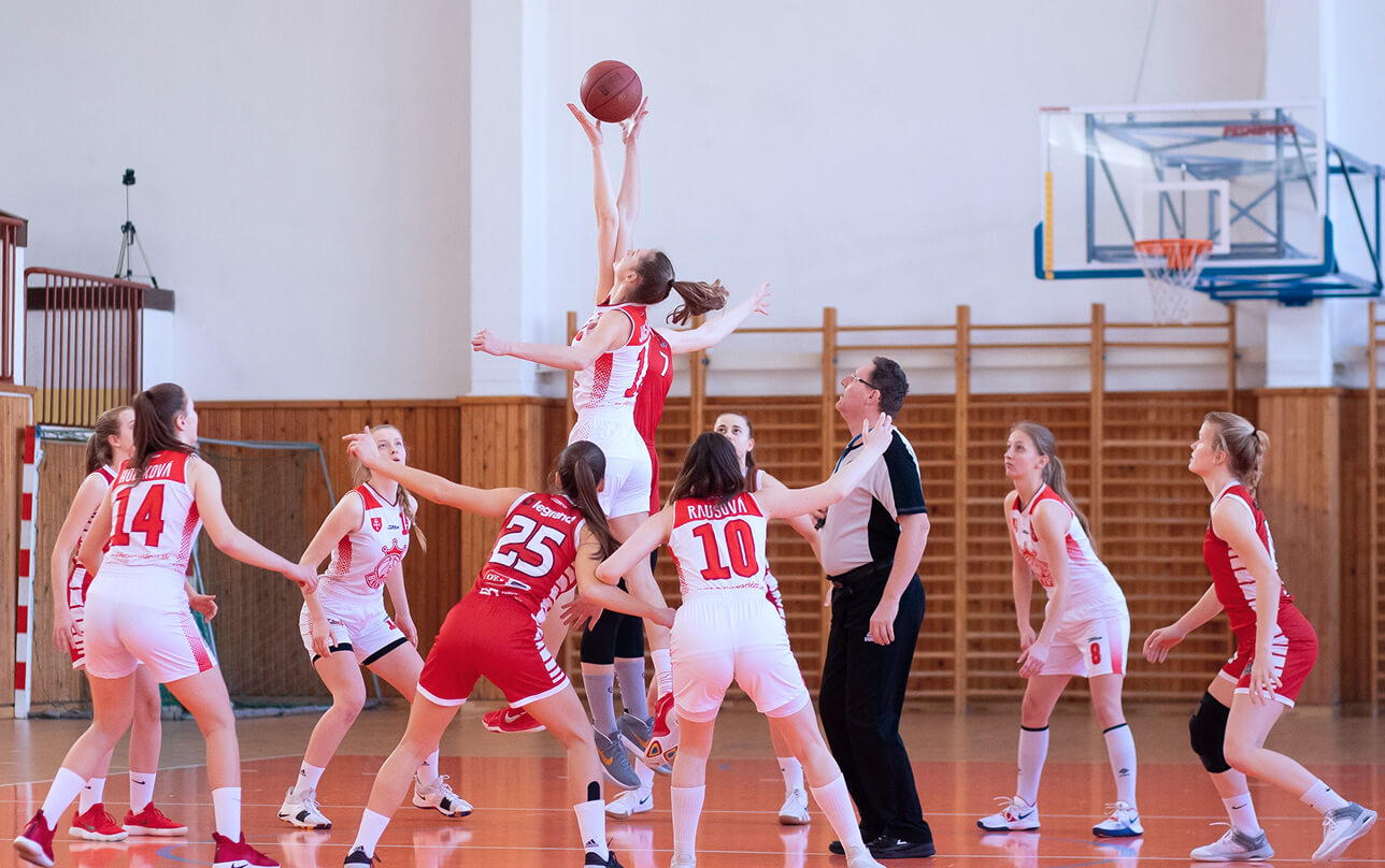 Two female basketball teams competing.