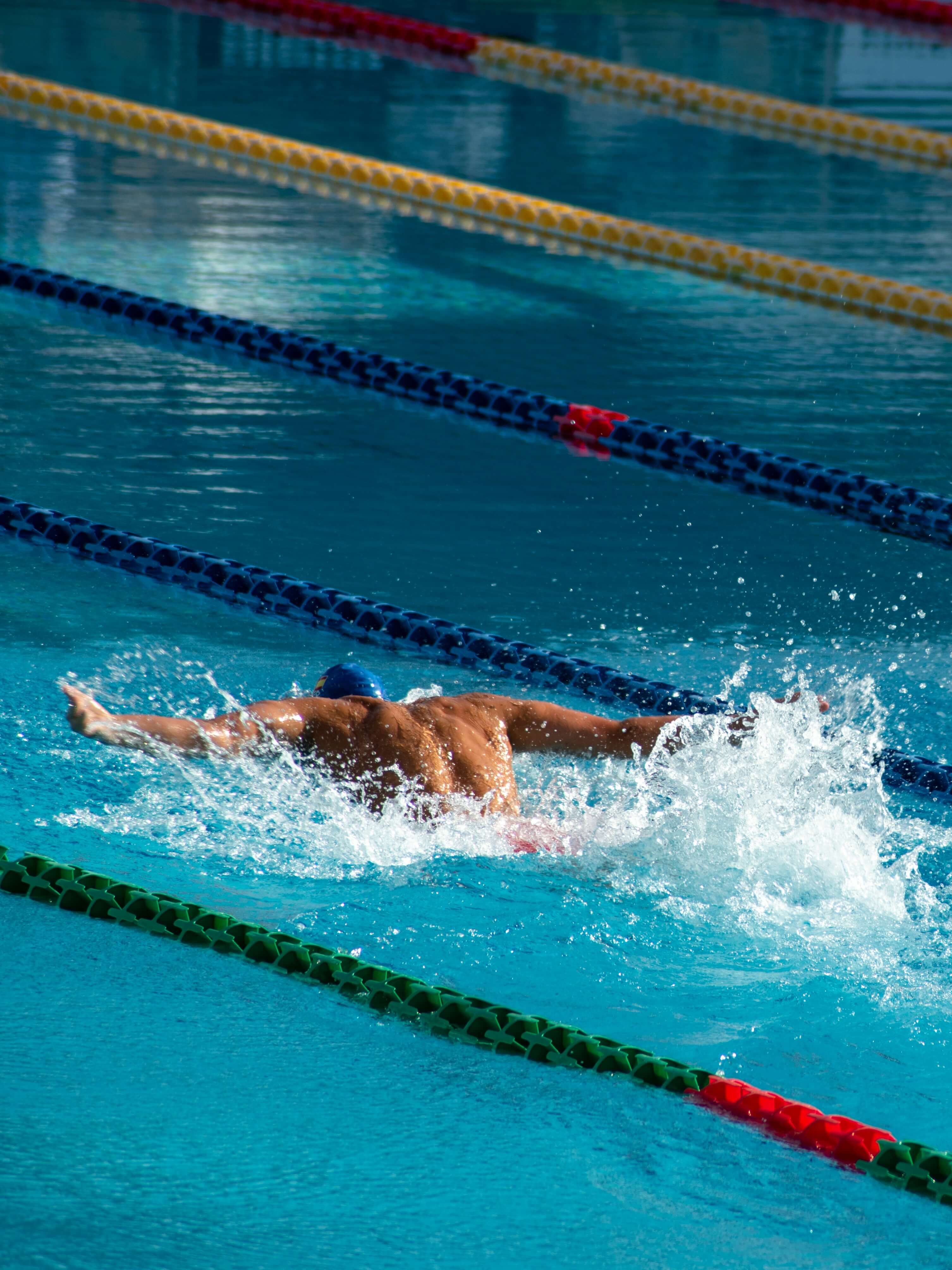 A professional swimmer is swimming in a pool.