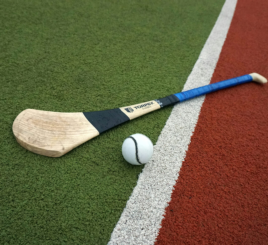 A hurley (Gaelic Games stick) lies on the playing field.