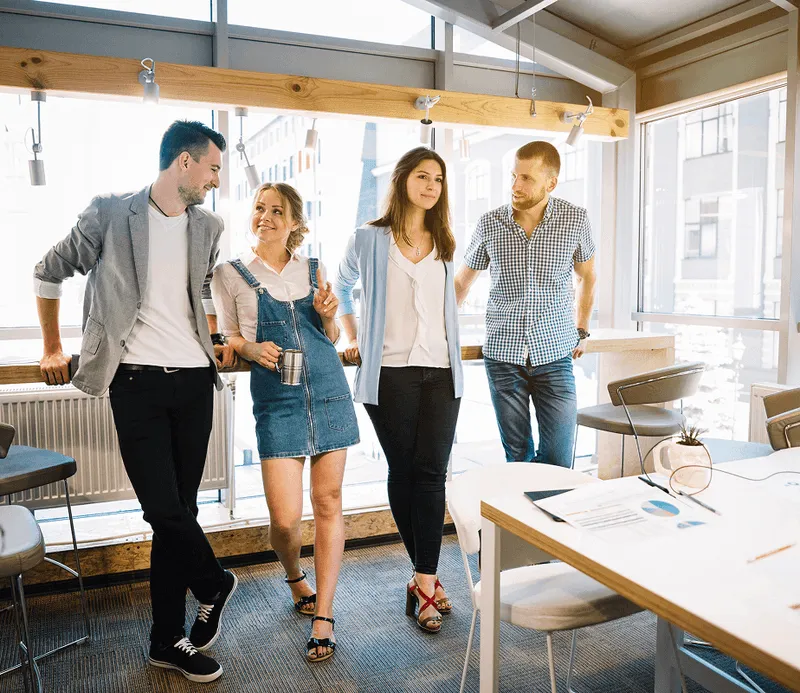 Four co-workers conversing