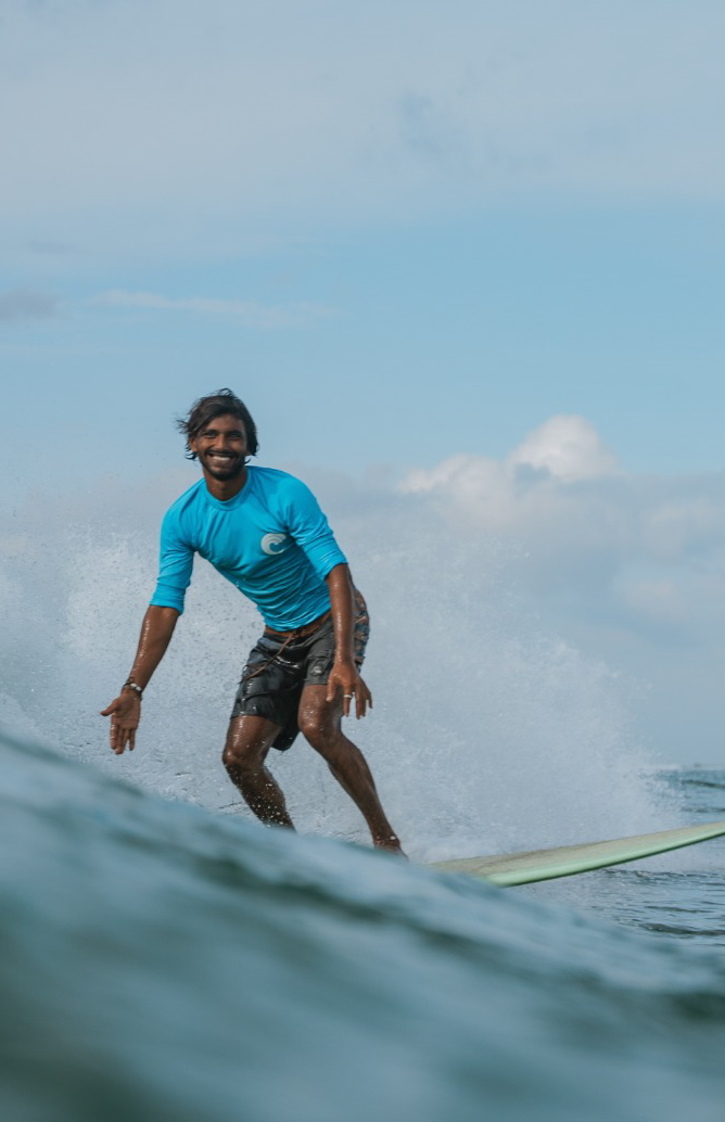 Surf session at Soul and Surf with a surfer balancing on a breaking wave in clear ocean water