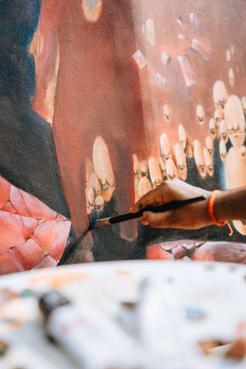 Artist painting a canvas during the Licuala artist residency in Ahangama, Sri Lanka
