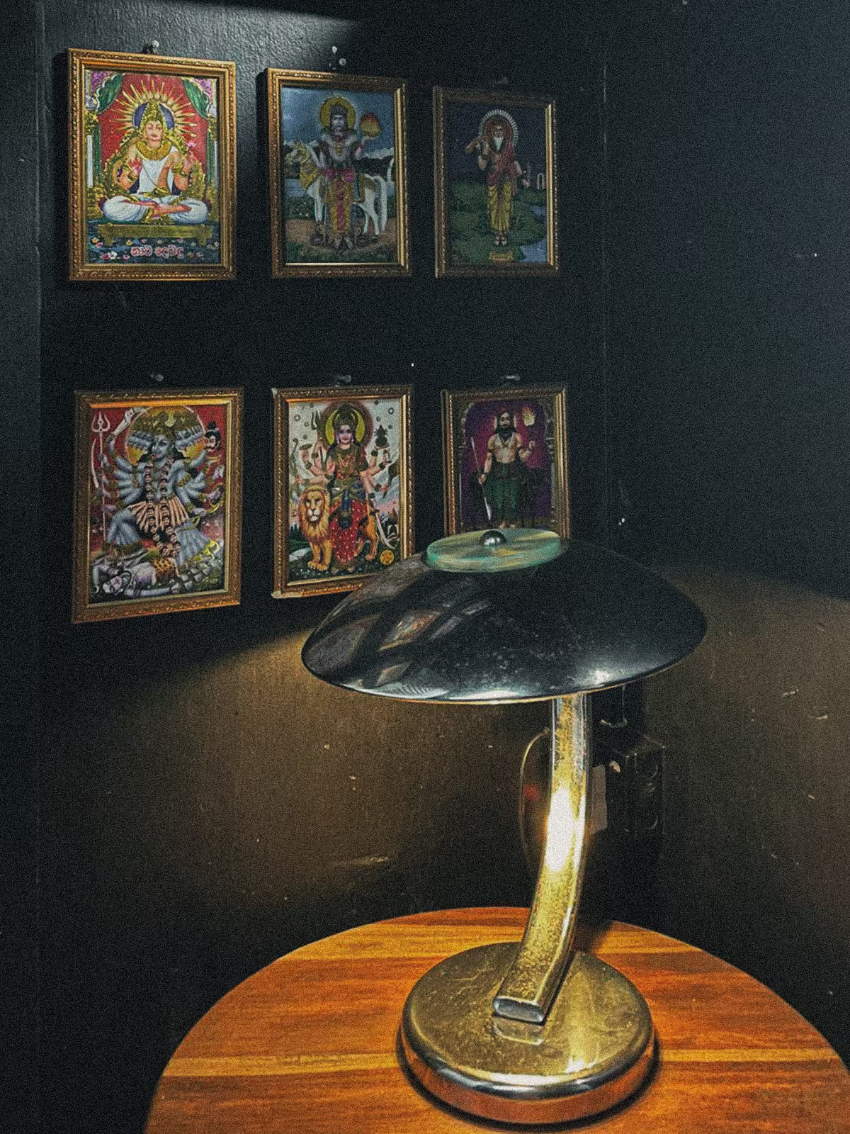 Surf Loft art corner with framed posters and vintage lamp.