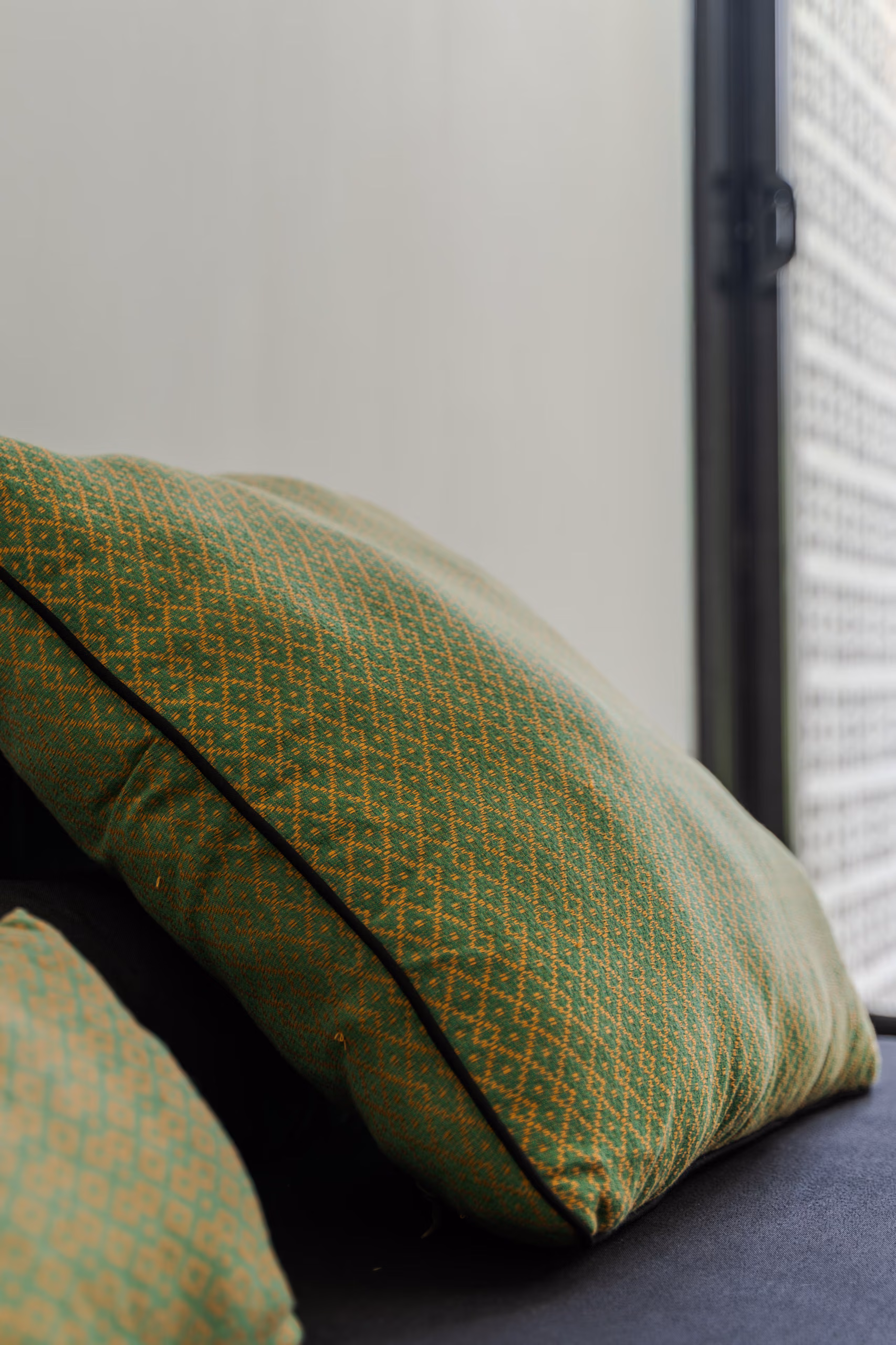 Patterned green cushions in the Garden House lounge at Licuala Lanka near Kabalana Beach, Sri Lanka