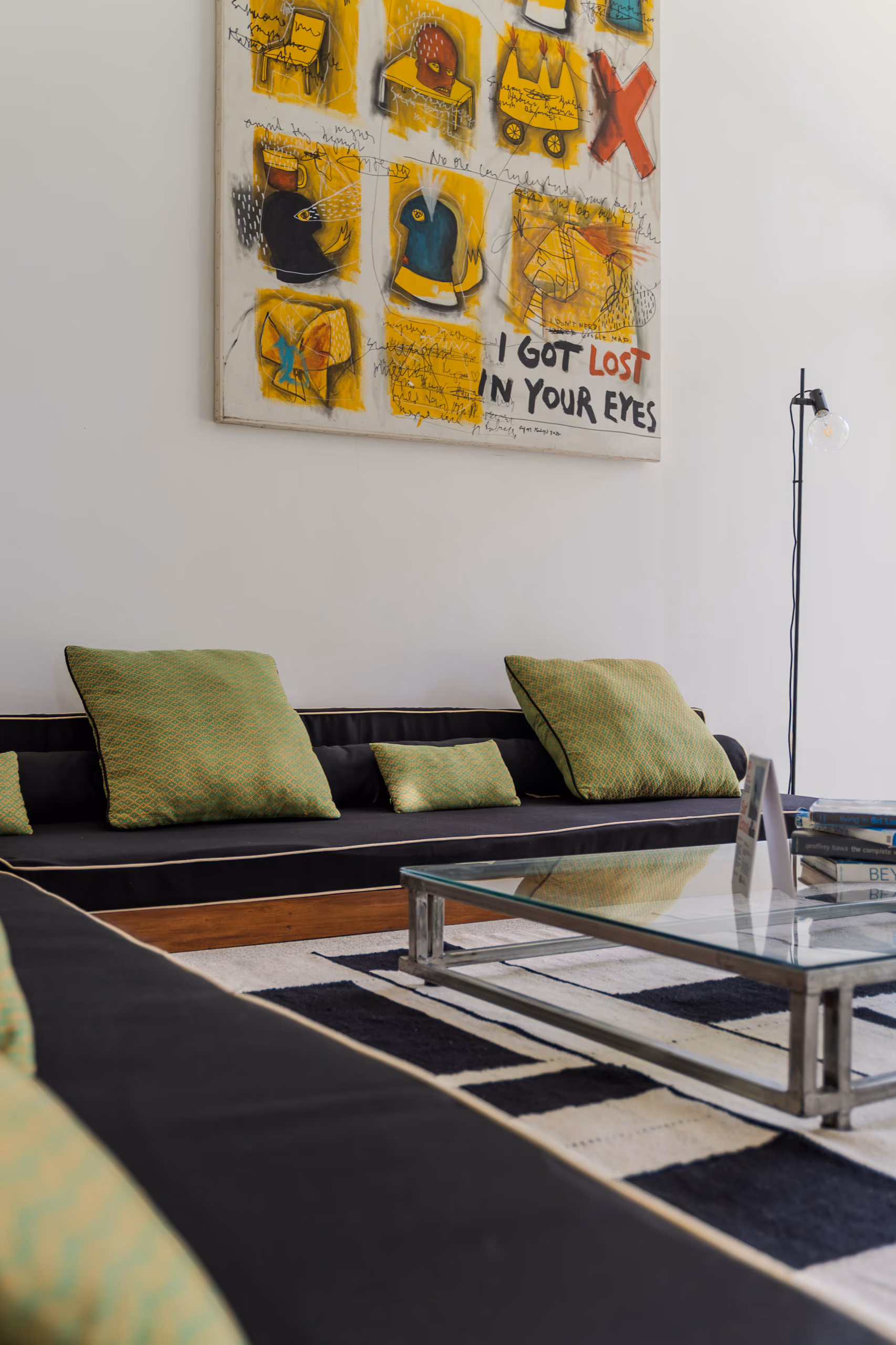 Lounge corner with green cushions and artwork in the Garden House at Licuala Lanka on Sri Lanka's South Coast