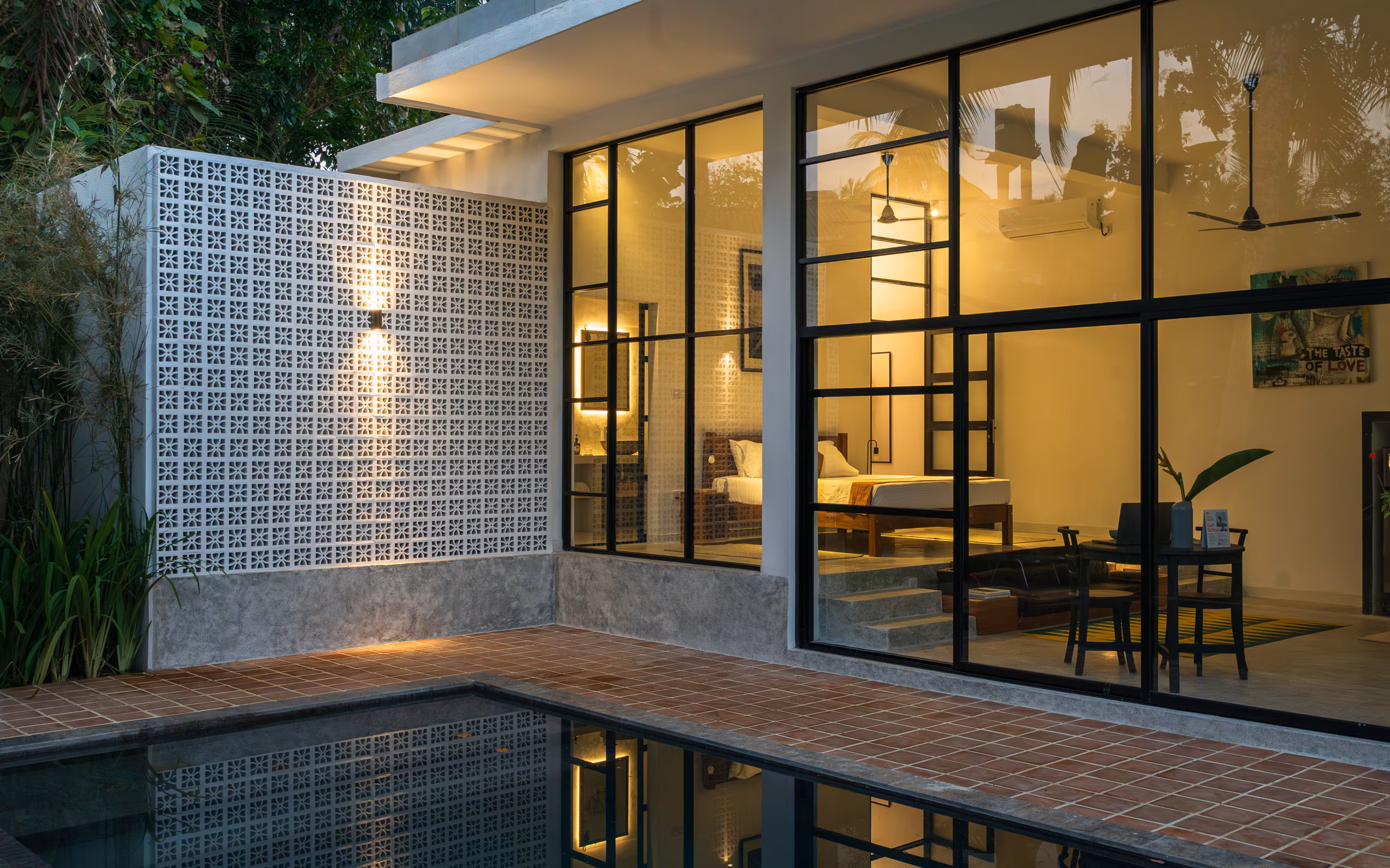 Plunge pool and glass facade of the Pool Bungalow at dusk, Licuala Lanka on Sri Lanka's South Coast