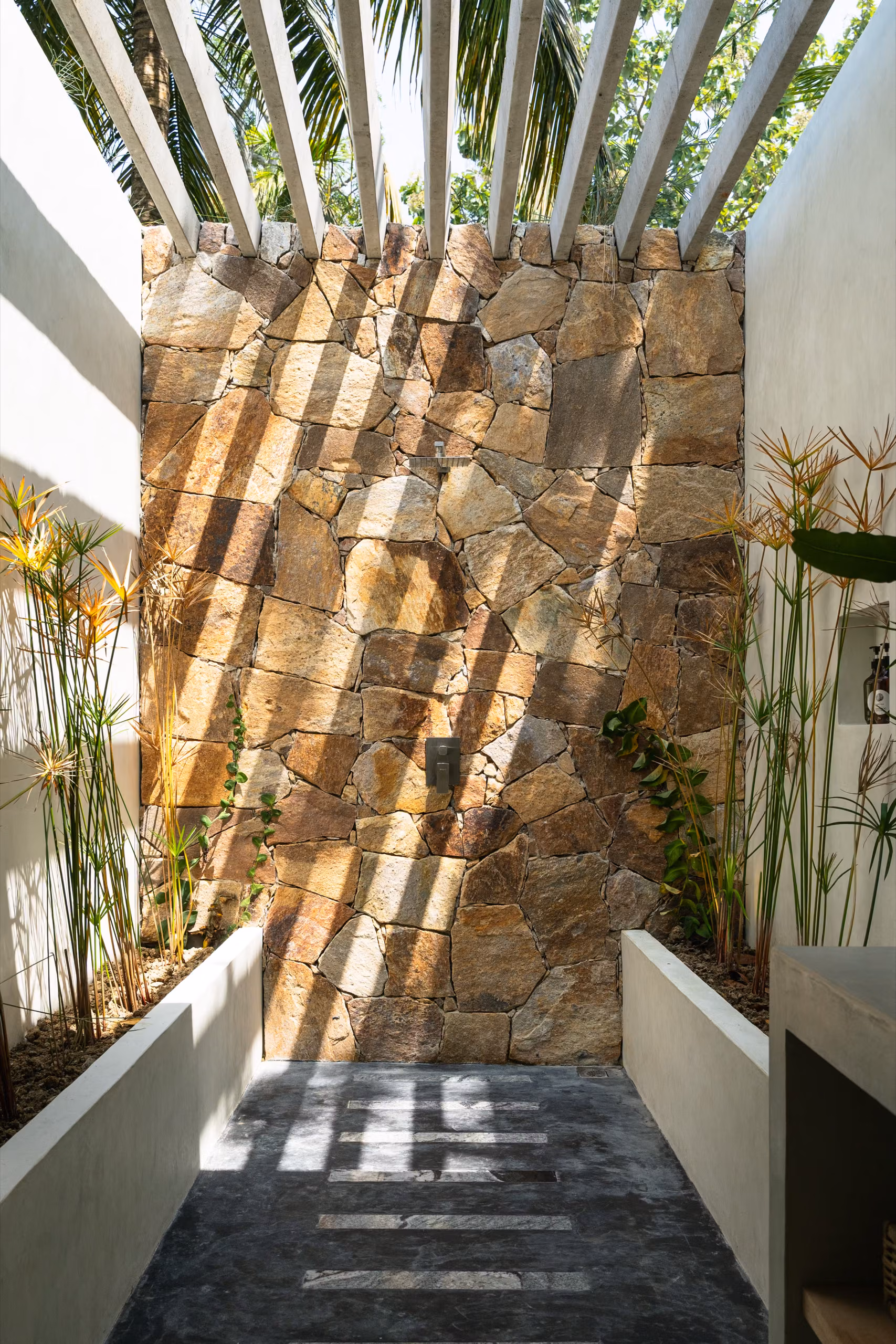 Stone wall and steps in the Pool Bungalow courtyard at Licuala Lanka near Kabalana Beach, Sri Lanka