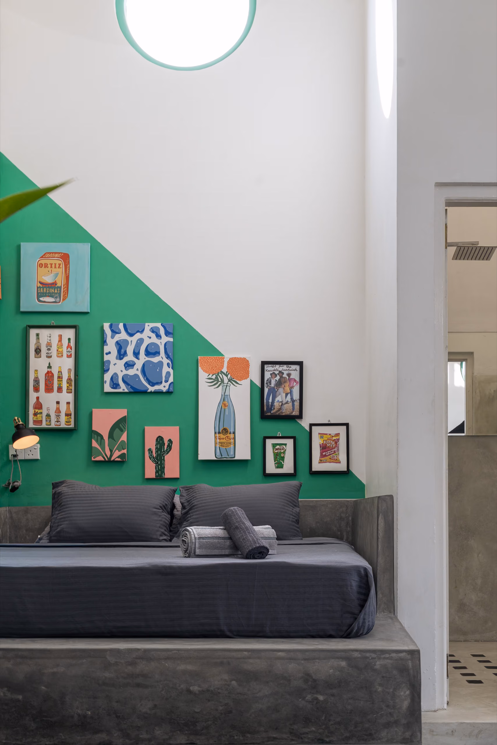 Platform bed with gallery wall in the Surf Loft at Licuala Lanka, Kabalana, Sri Lanka