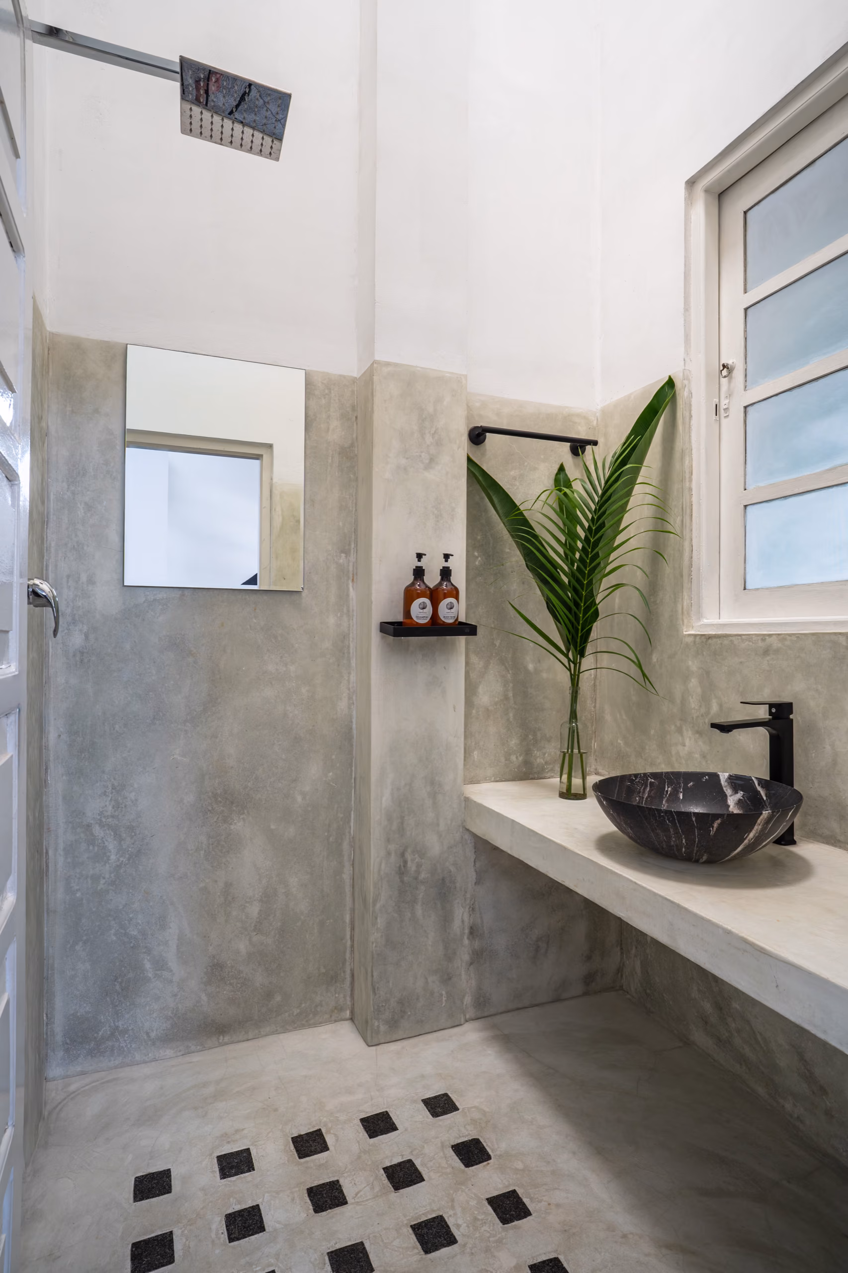 Concrete shower with black basin in the Surf Loft, Licuala Lanka, Ahangama, Sri Lanka