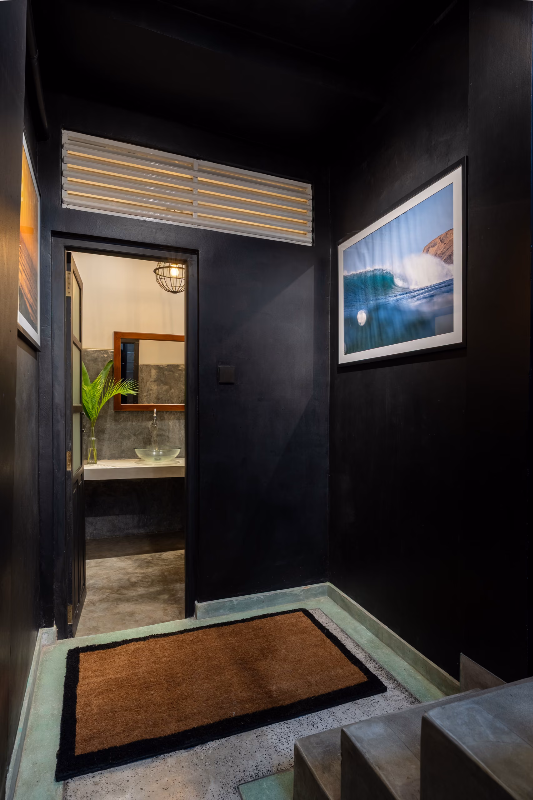 Black hallway with surf photography in the Surf Loft, Kabalana, Sri Lanka