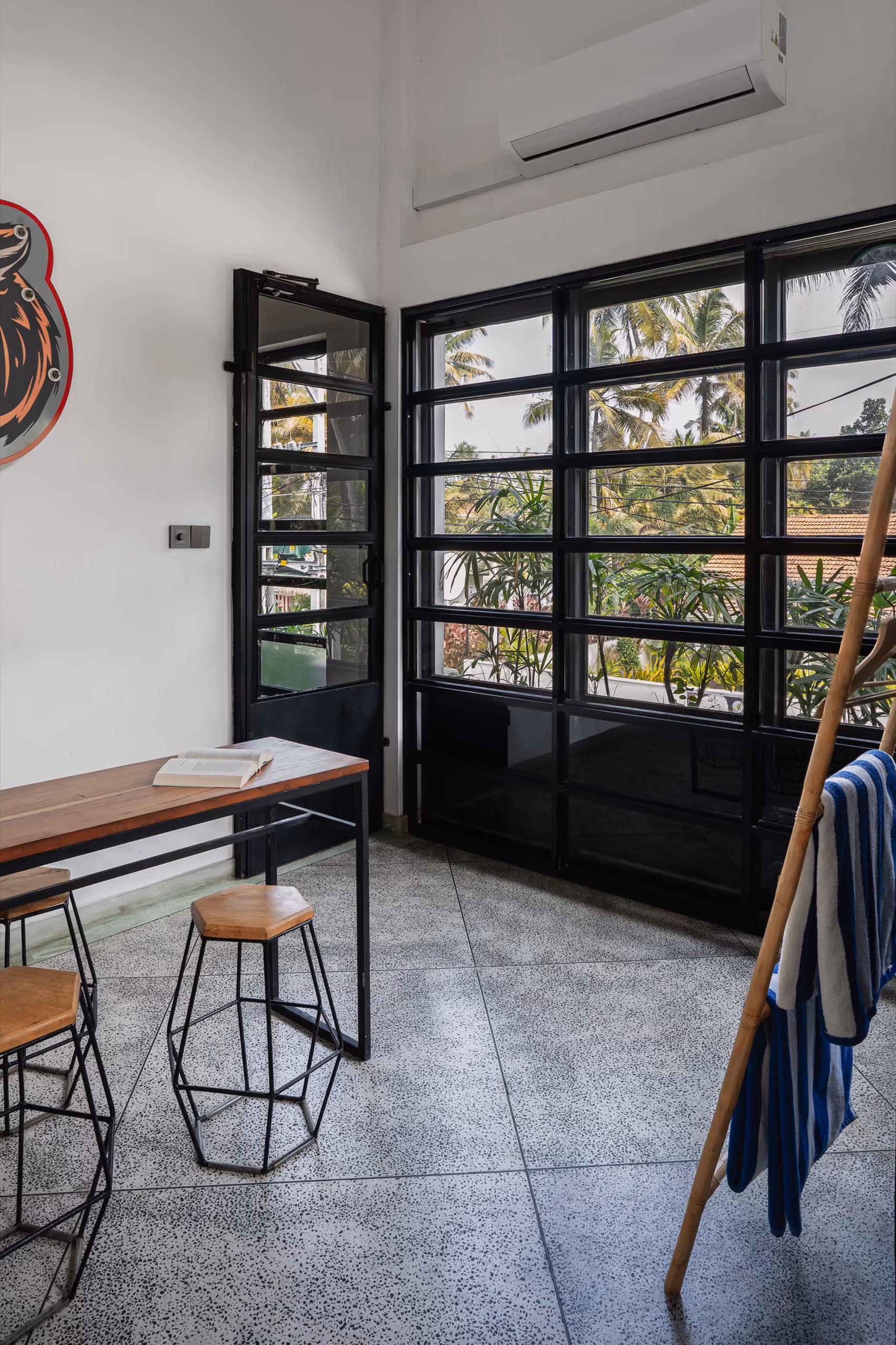 Dining table and factory windows inside the Surf Loft, Kabalana, Sri Lanka