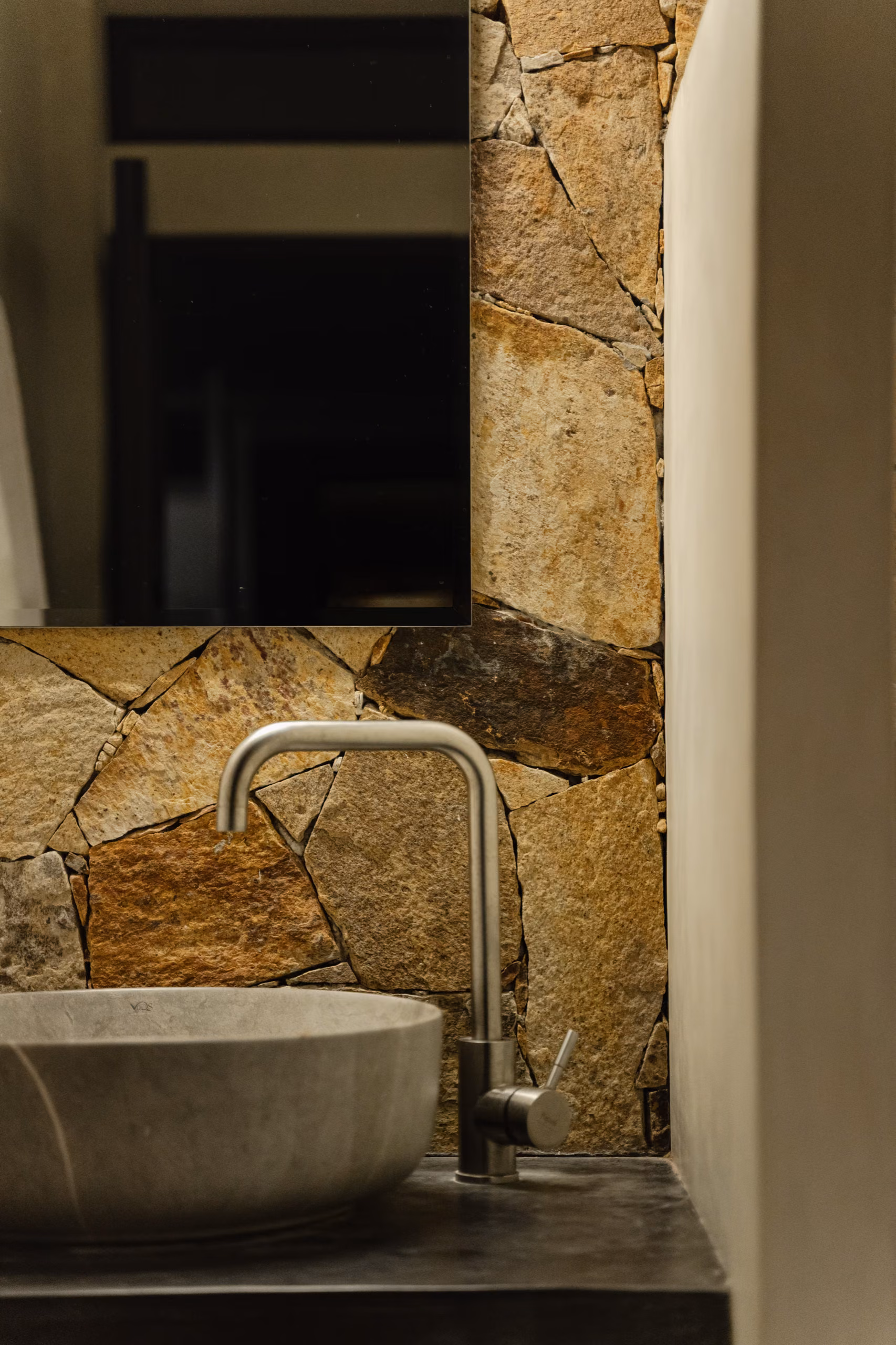 Stone wall and concrete basin in the Tropical House bathroom, Licuala Lanka on Sri Lanka's South Coast