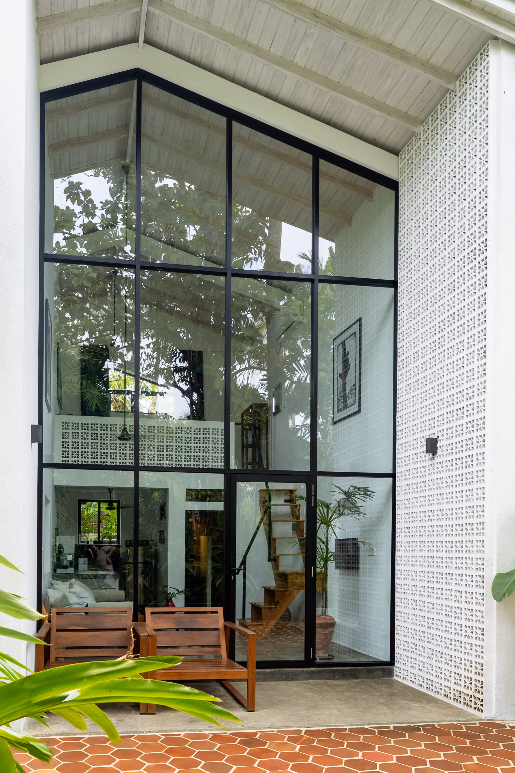 Floor-to-ceiling glass gable facade of the Tropical House at Licuala Lanka near Kabalana Beach, Sri Lanka