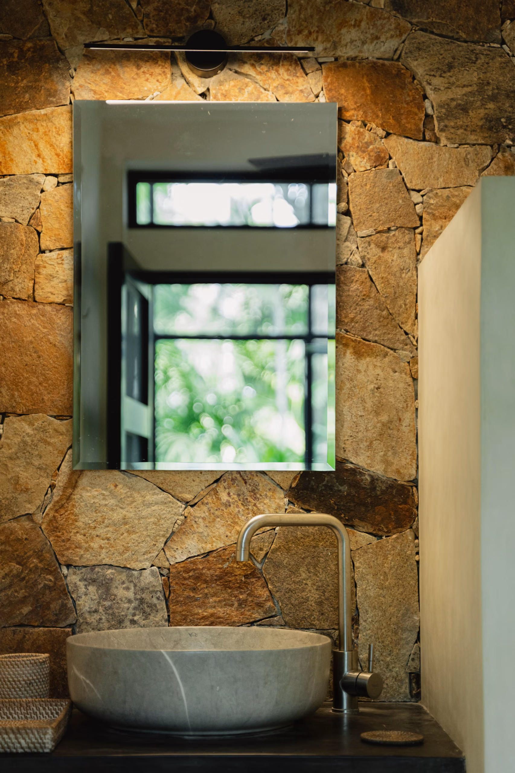 Stone bathroom with open window in the Tropical House at Licuala Lanka, Ahangama, Sri Lanka