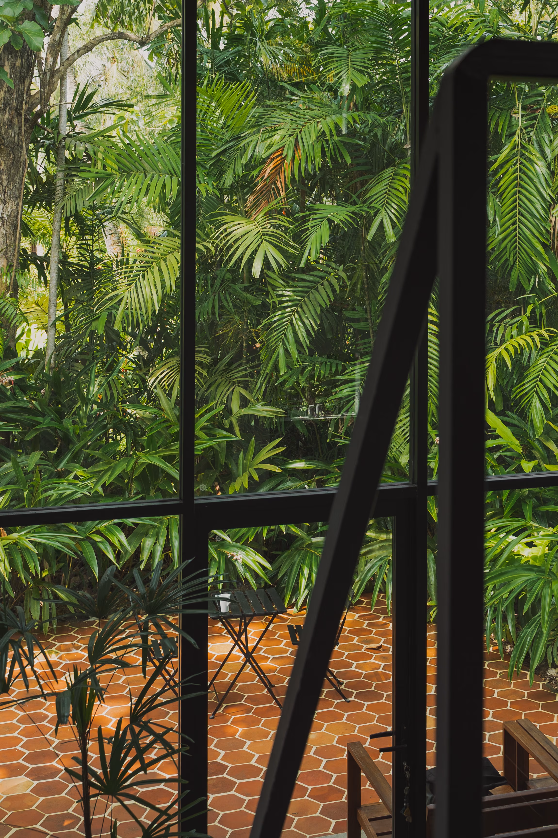Glass doors opening to the jungle at the Tropical House, Licuala Lanka on Sri Lanka's South Coast
