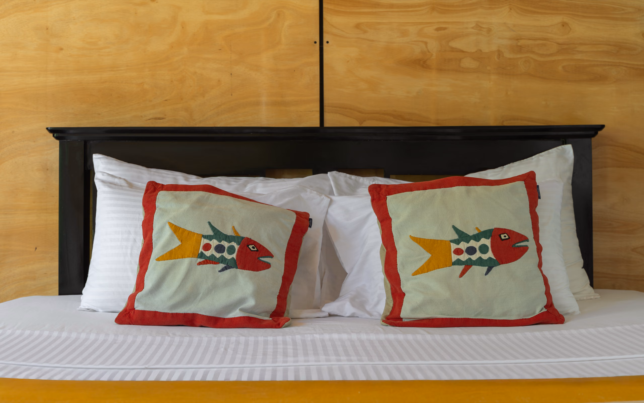 Sri Lankan fish applique cushions on the Jungle Bungalow bed, Licuala Lanka