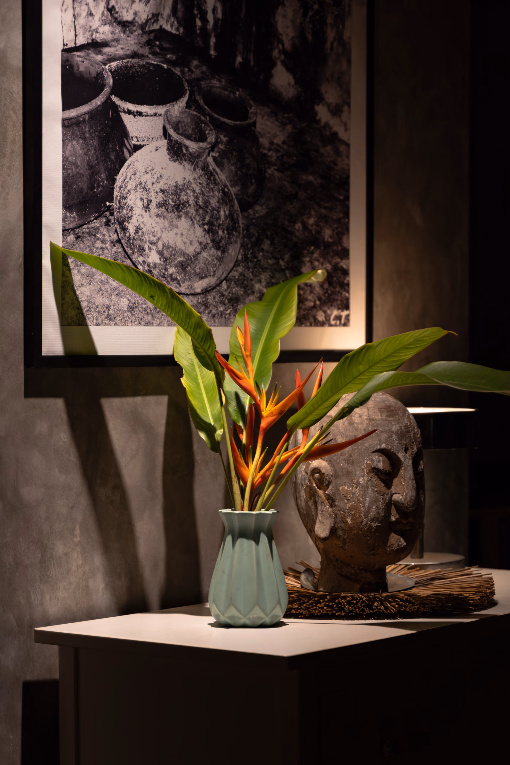 Buddha head and heliconia still life in the Jungle Bungalow, Licuala Lanka near Kabalana Beach, Sri Lanka