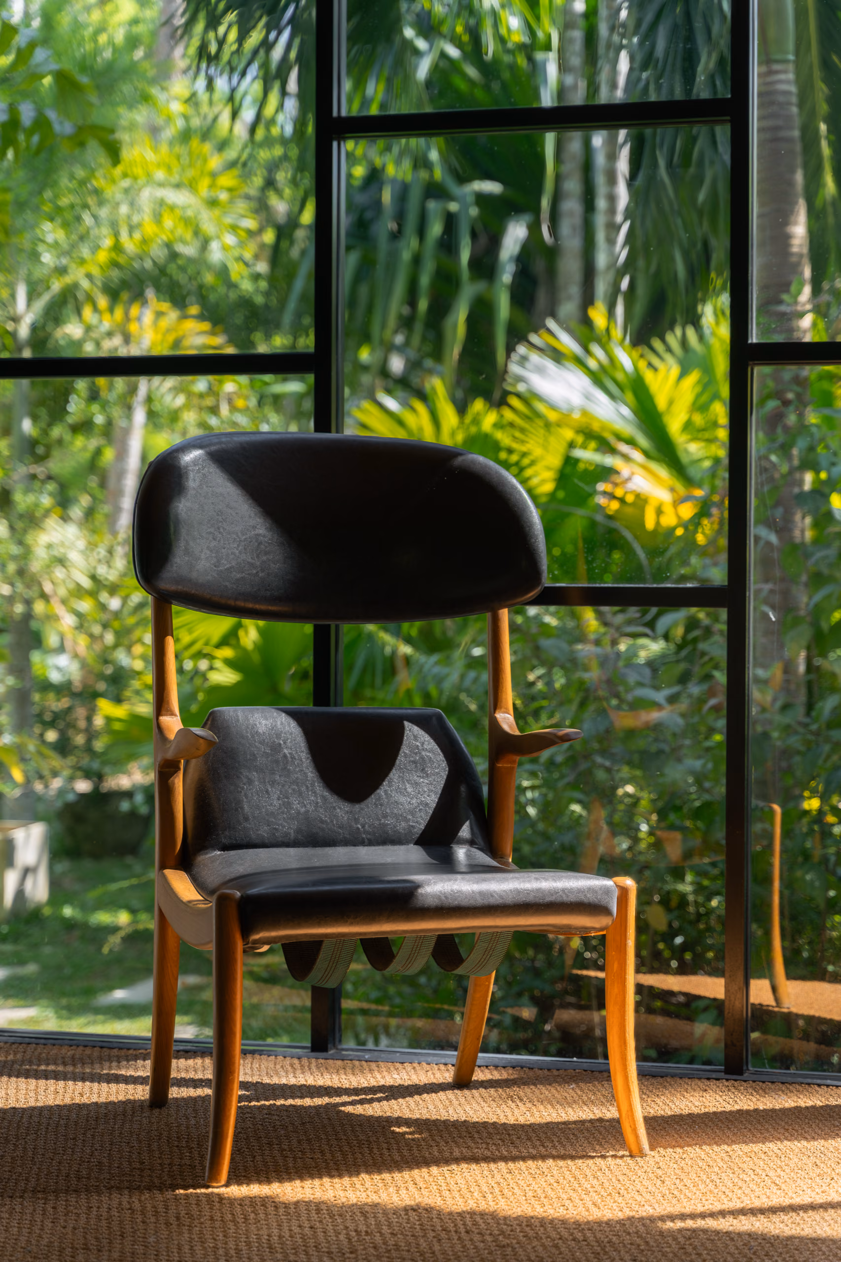 Leather and wood chair by the window in the Jungle Bungalow, Licuala Lanka on Sri Lanka's South Coast