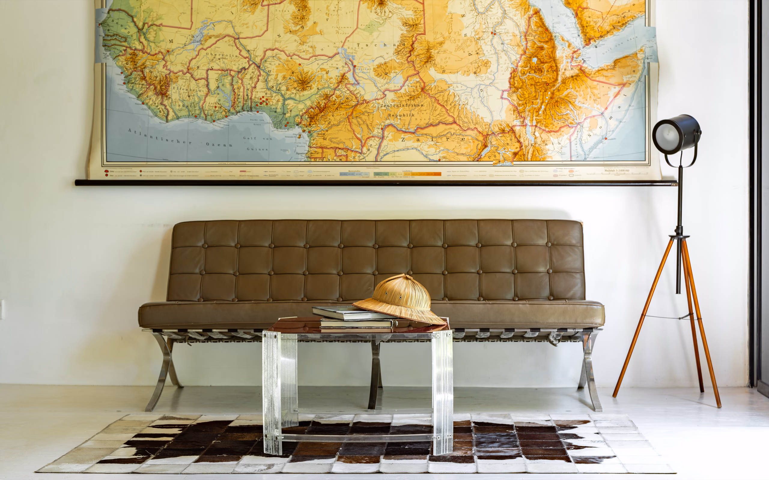 Lounge with vintage map and tripod lamp in the Jungle Bungalow, Licuala Lanka near Kabalana Beach, Sri Lanka