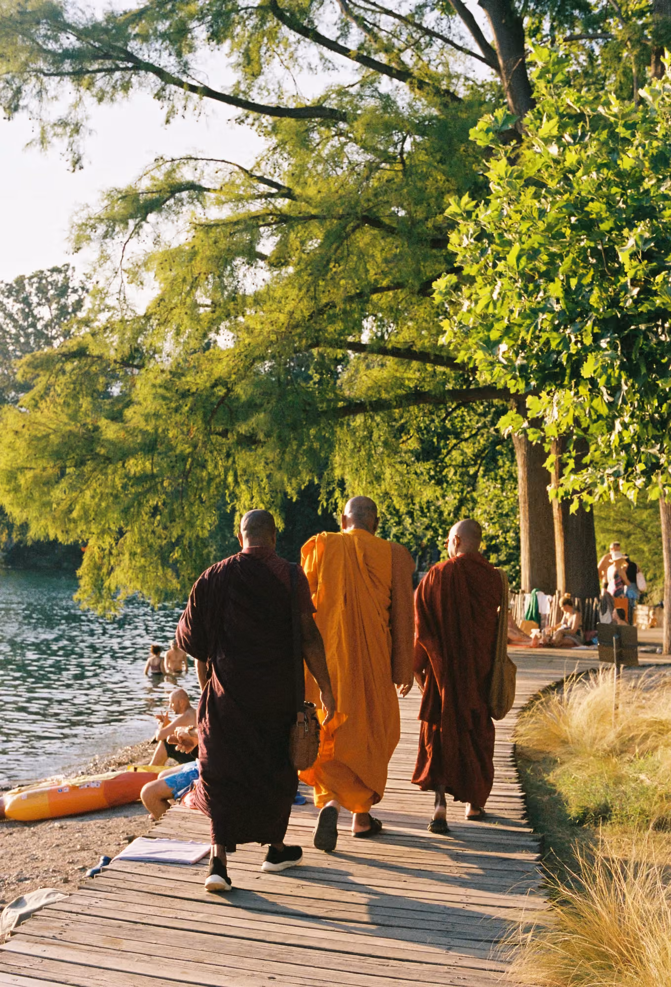 Buddhist monks walking a lakeside path in Sri Lanka, from the Licuala journal