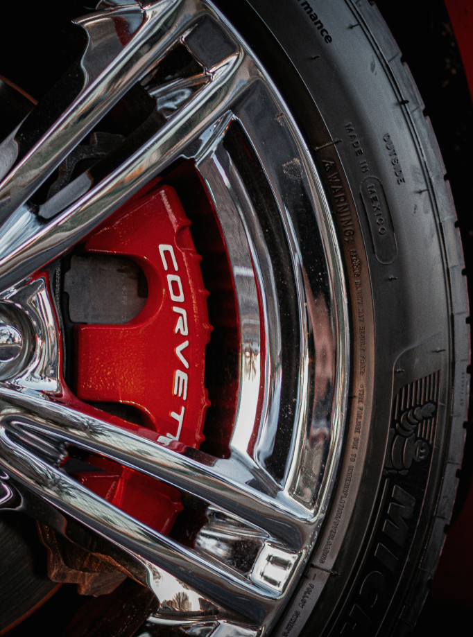 Detailed view of a red brake caliper and a wheel