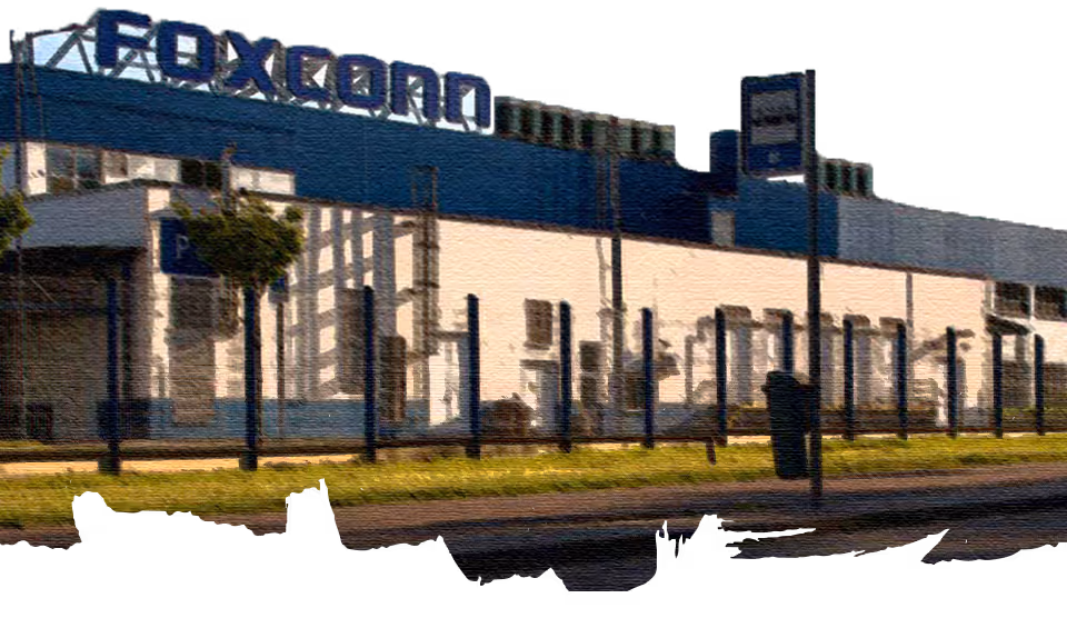 Exterior view of a Foxconn factory building with a fence and a parking sign in front.