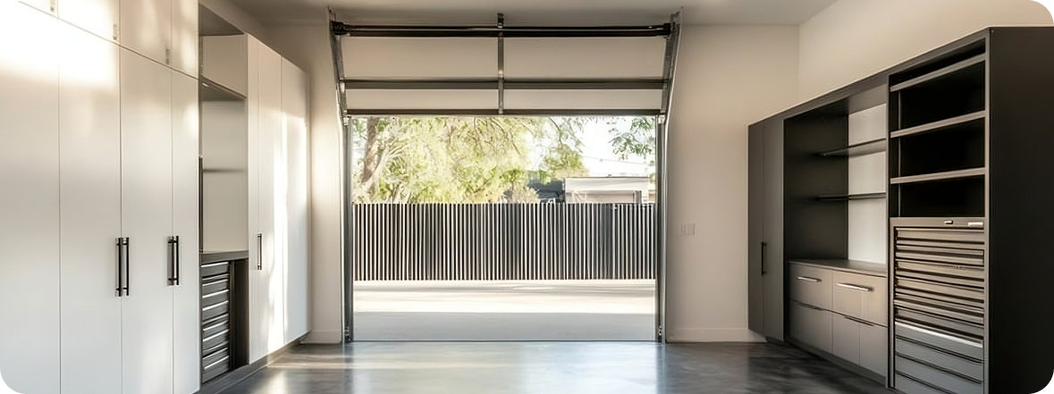 Modern garage with floor-to-ceiling custom storage and workbench