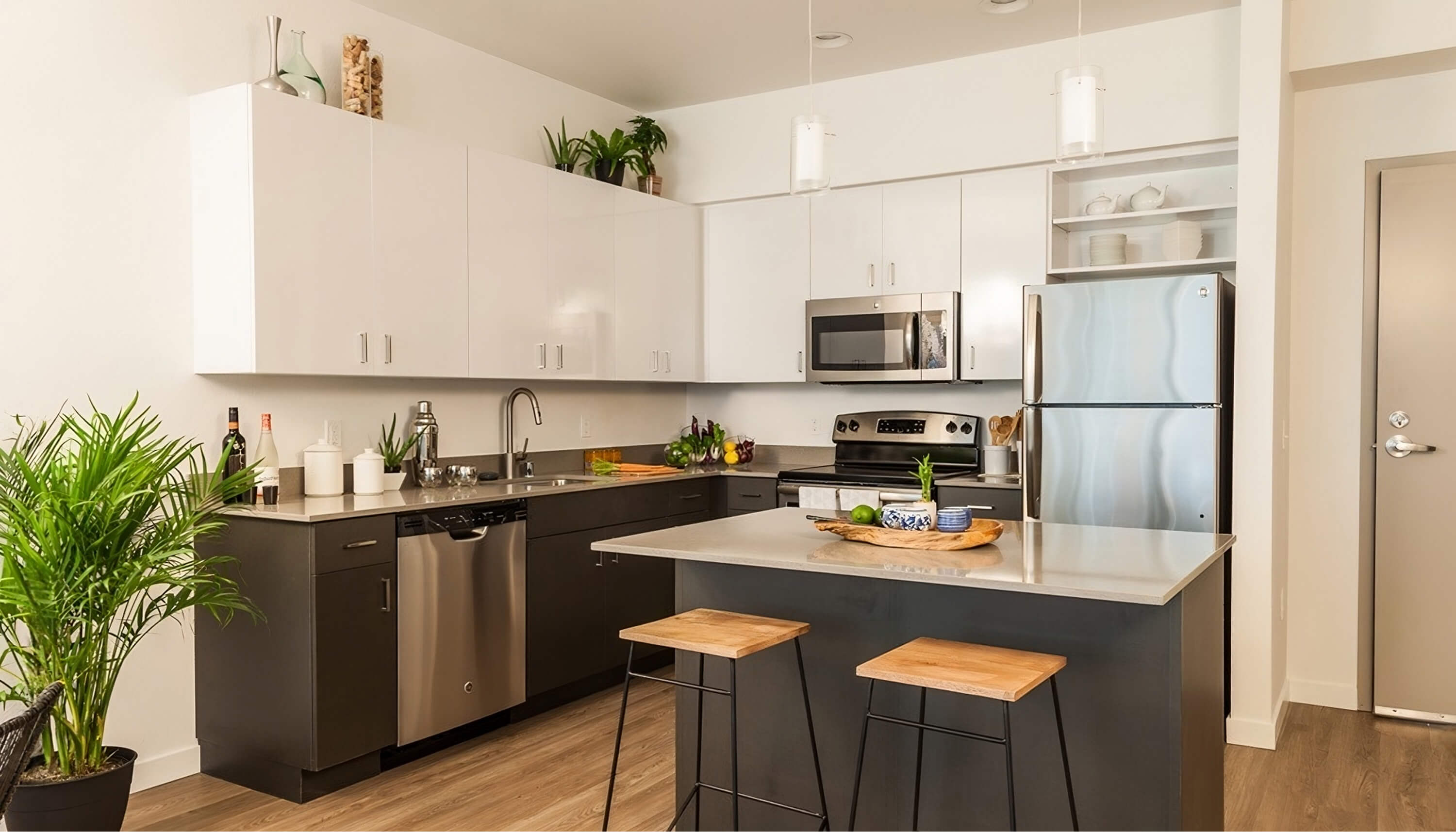 Kitchen with natural wood island and modern upper cabinets