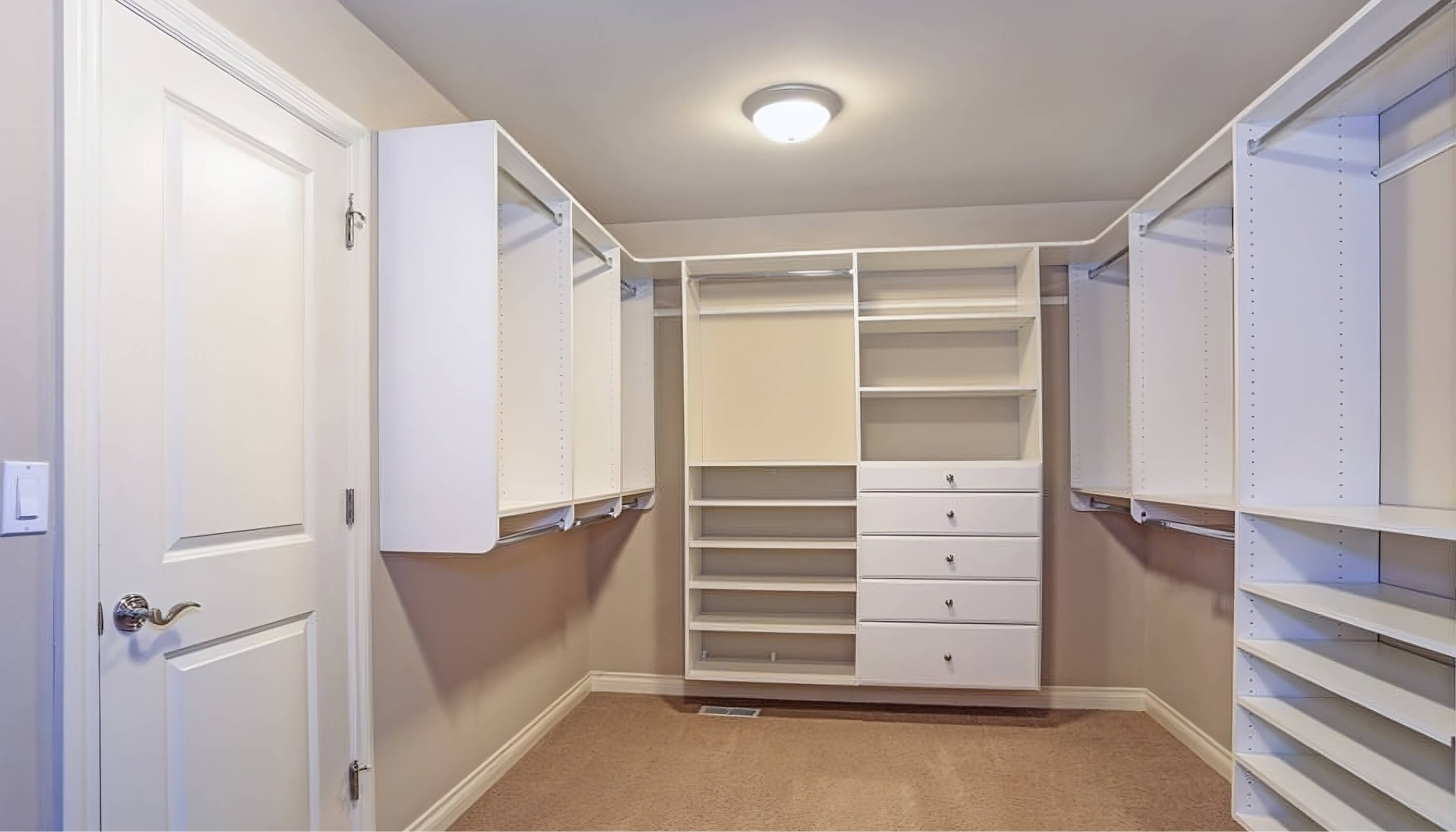 Spacious walk-in closet with island and built-in drawers