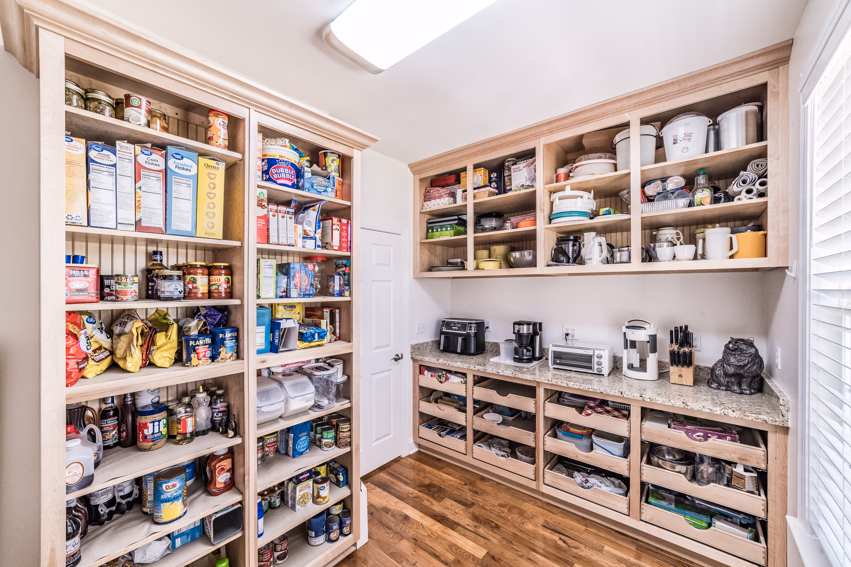 Kitchen island cabinetry with exposed beams and custom wood finish