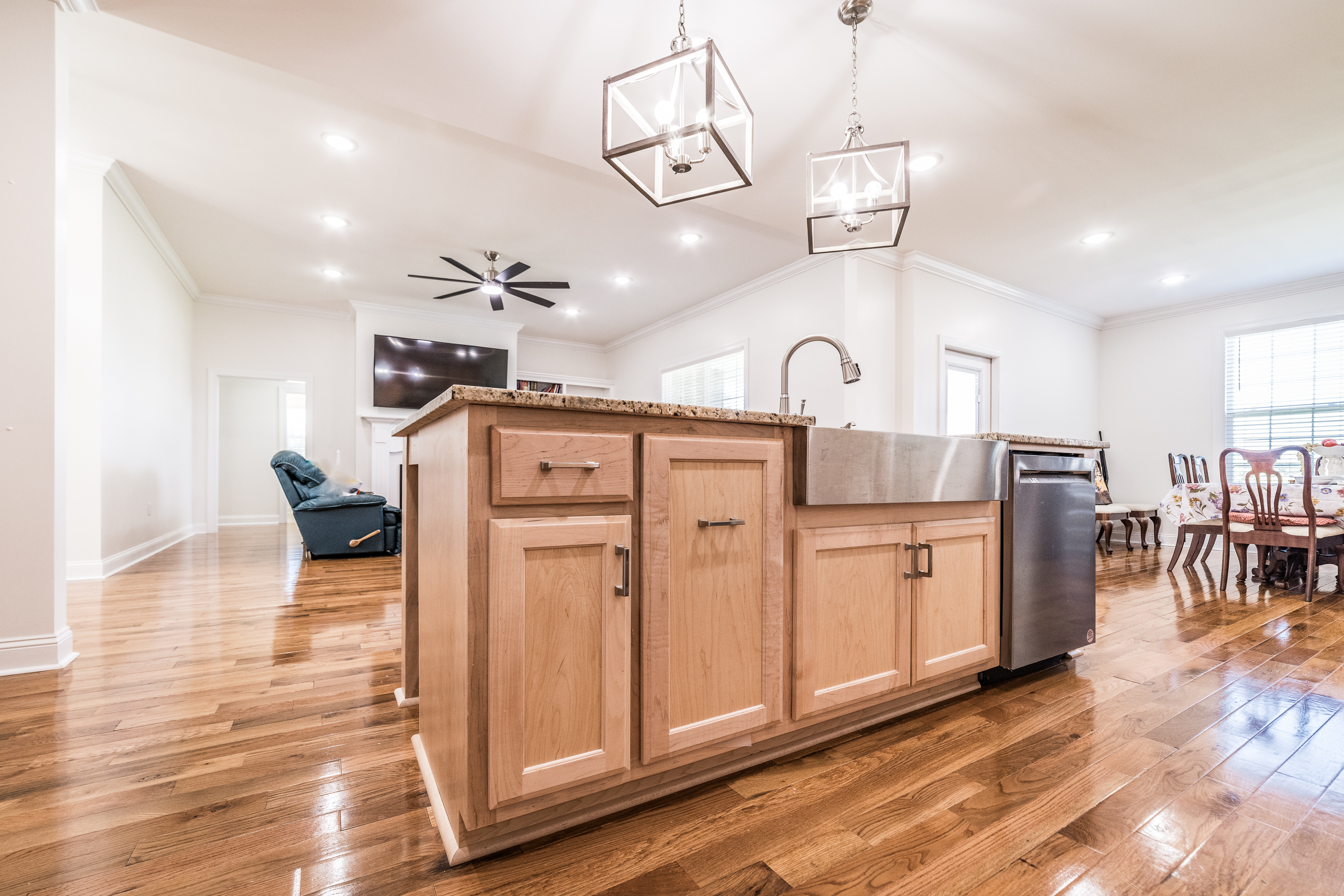 Luxury kitchen with island cabinetry and chandelier lighting