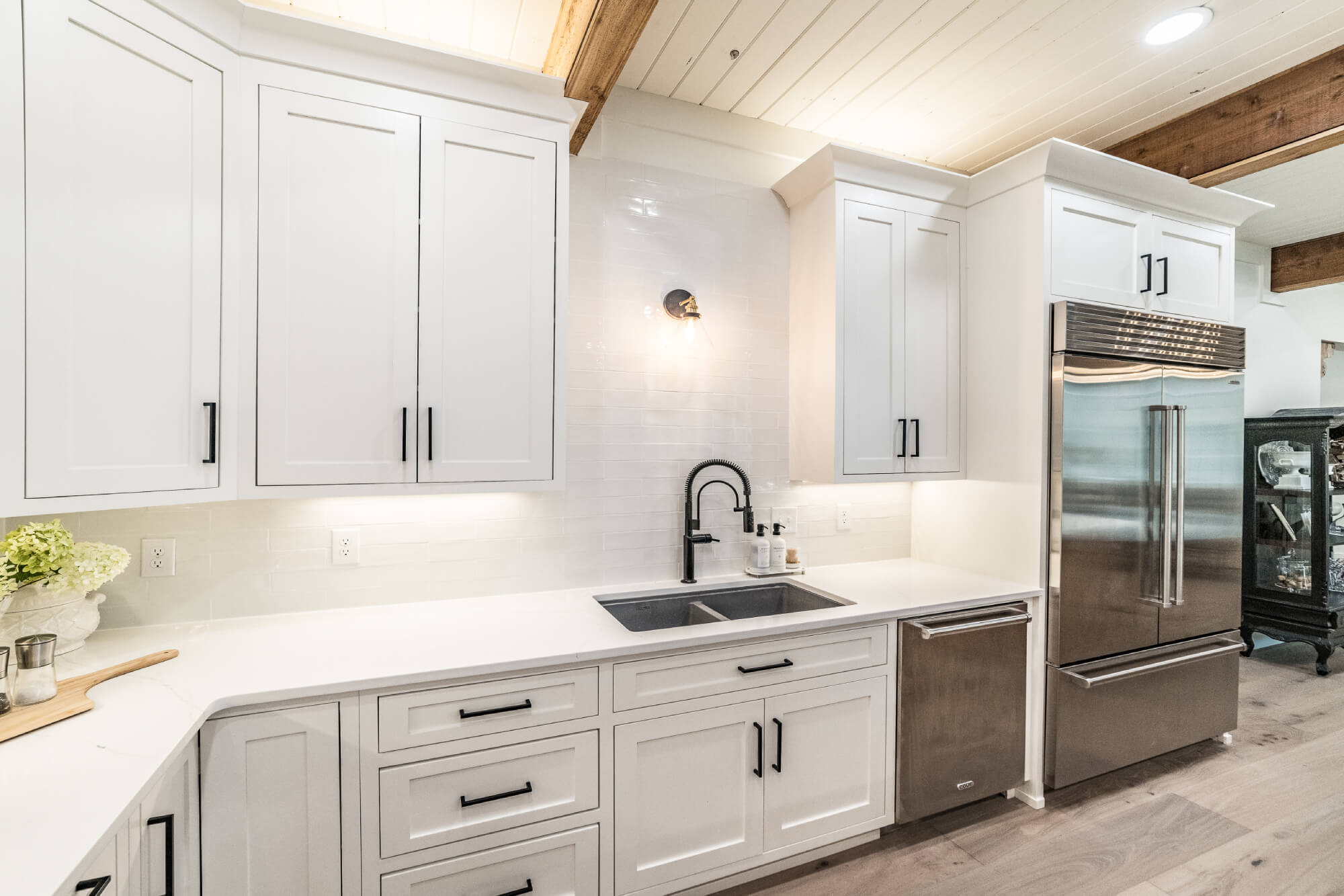 White custom kitchen cabinets with built-in microwave and oven