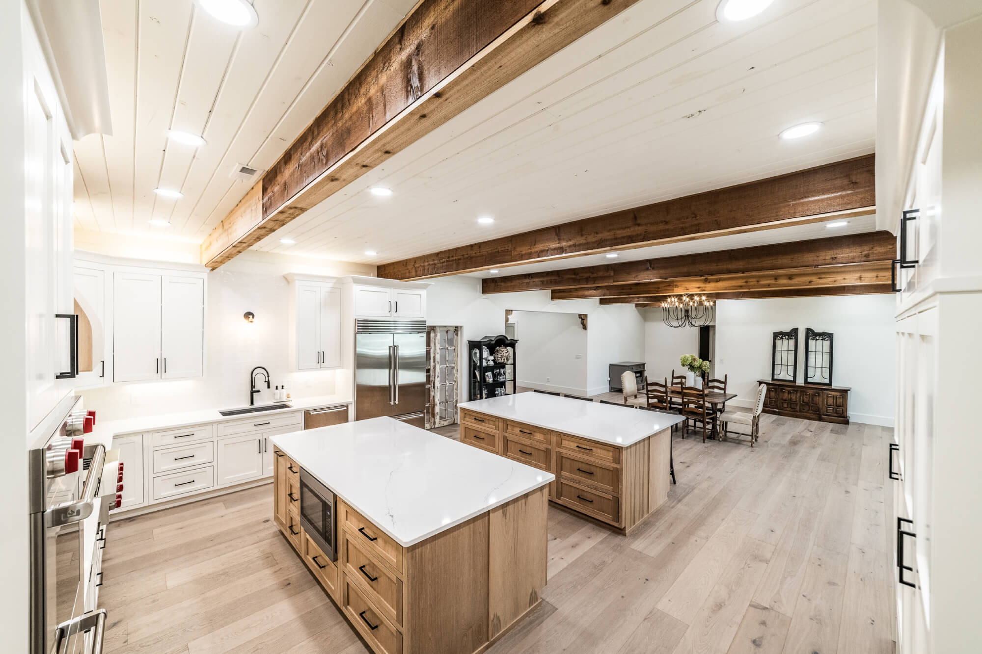Bright kitchen cabinetry with exposed beams and large island