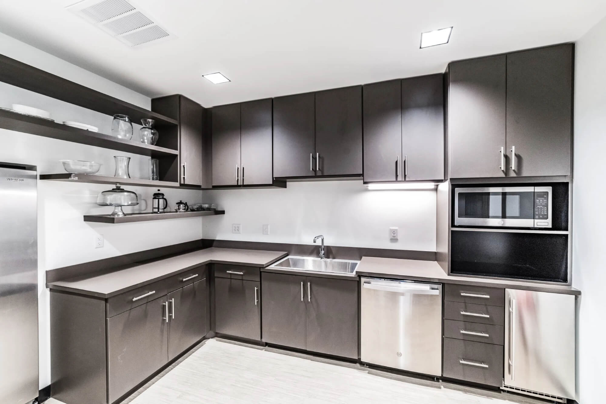 Modern kitchen with dark custom cabinetry and stainless appliances