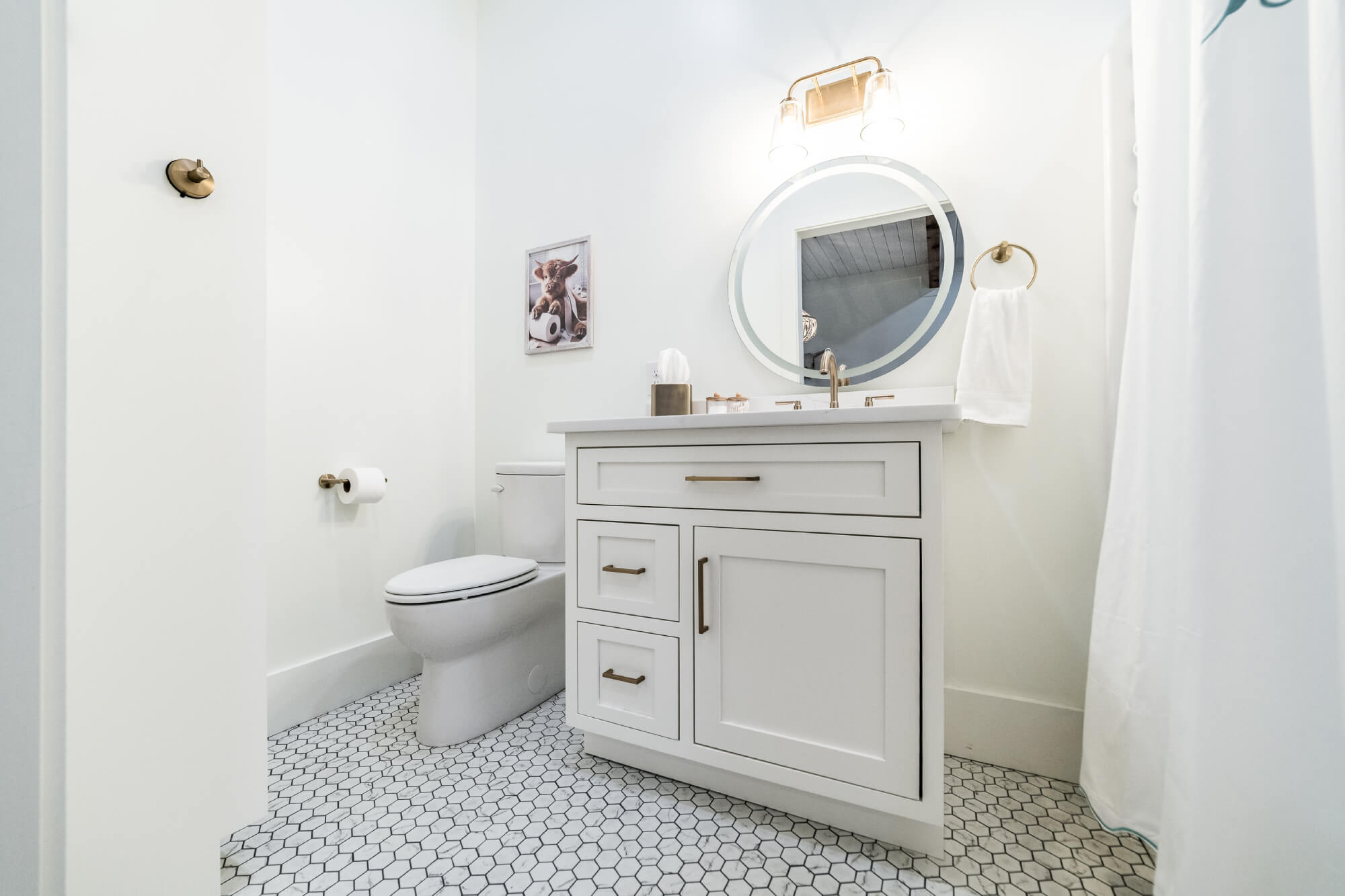 White bathroom cabinetry with side storage and mirror