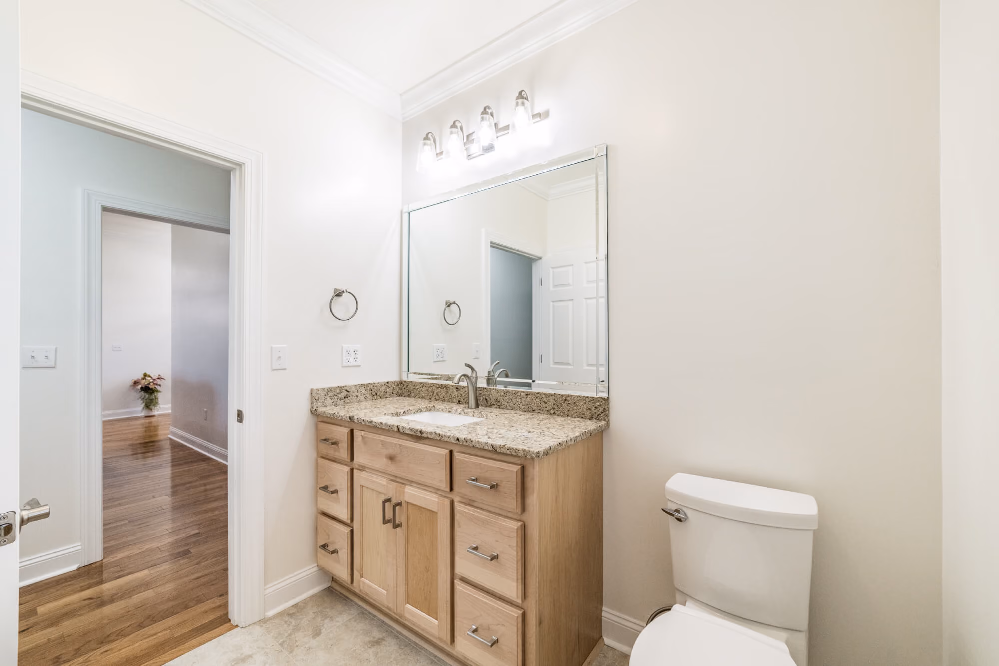 Custom wood vanity with granite top in bathroom